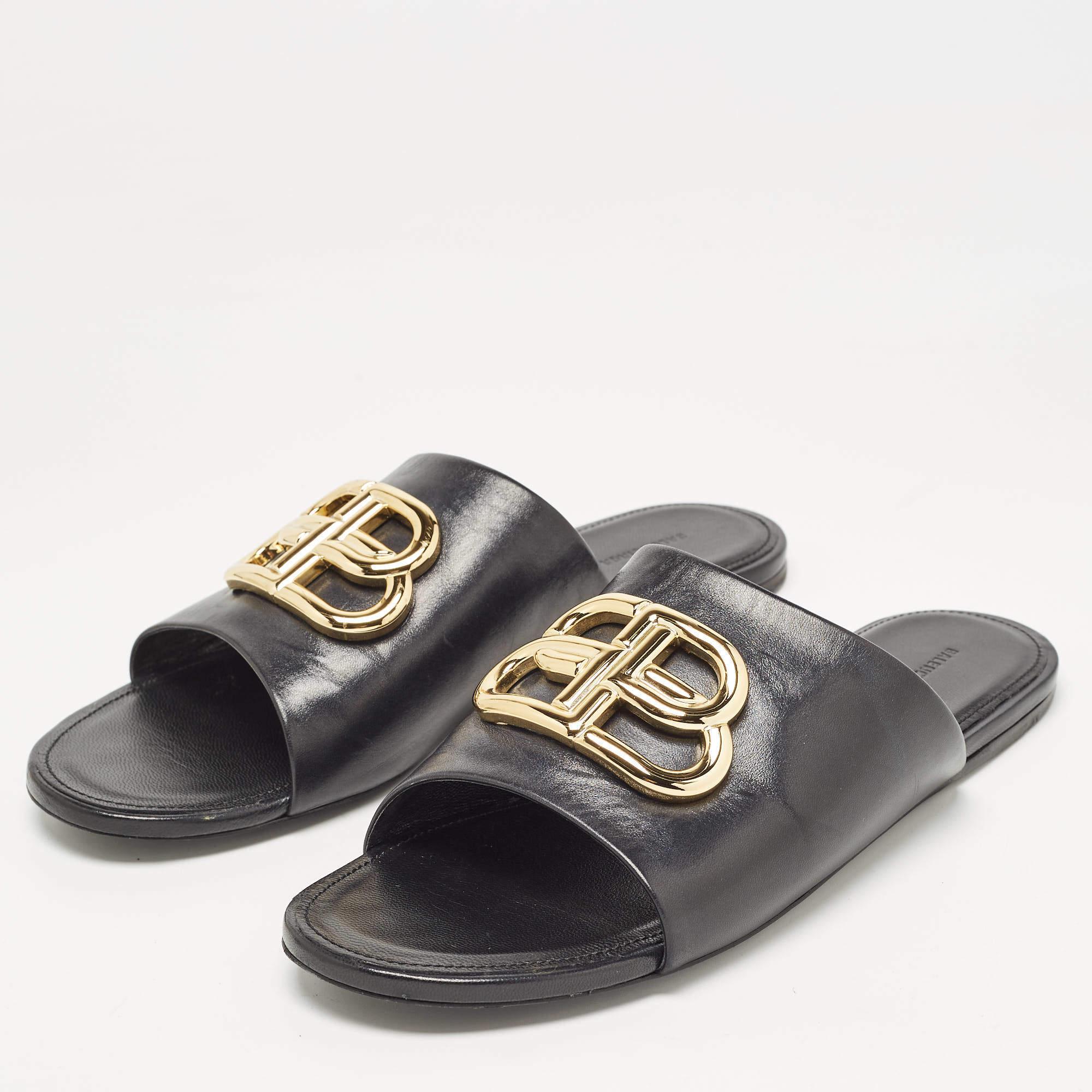 Supremely comfortable and stylish, these slides from the house of Balenciaga features a black leather design. They come with gold-tone BB detailing on the uppers and lined insoles. Team the slides with culottes or cropped trousers to show them off.

