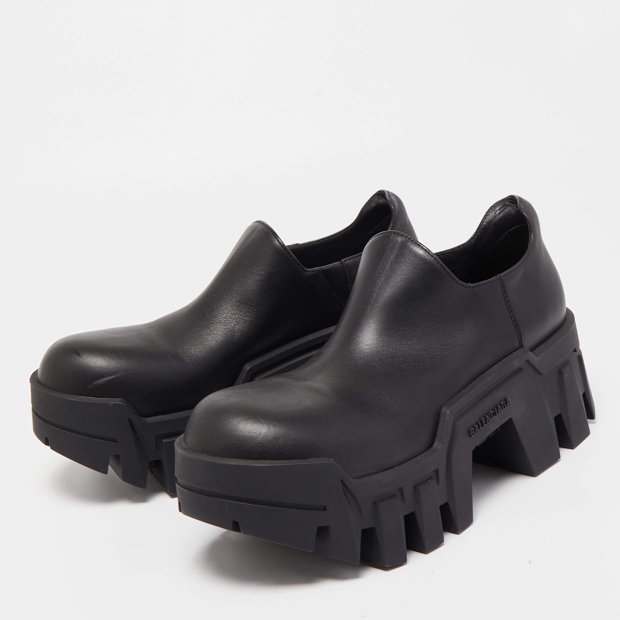 The Balenciaga Bulldozer boots are a fashion statement with their sleek black leather construction. These ankle boots feature a chunky sole reminiscent of a bulldozer tread, adding an edgy and distinctive touch to any outfit.

