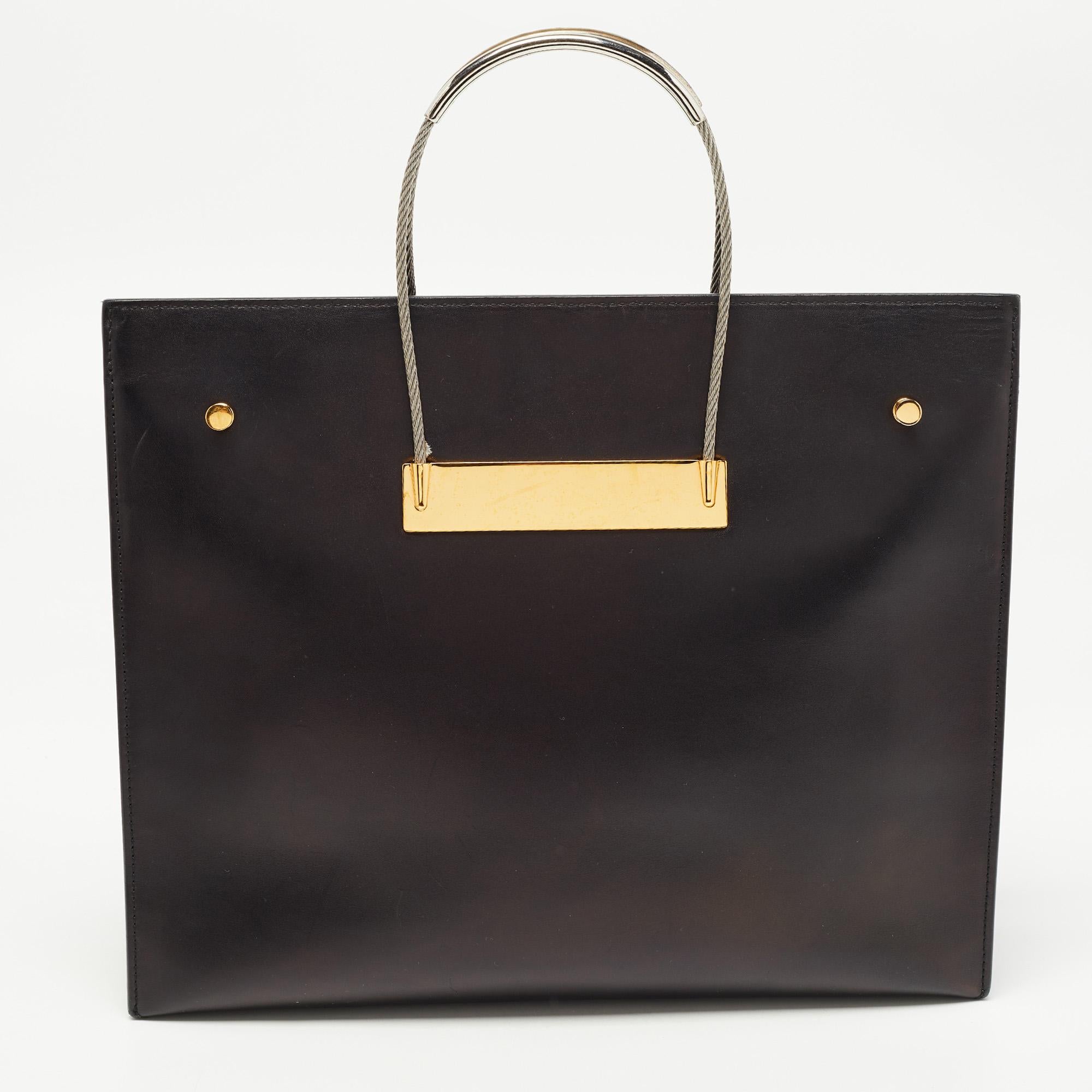 This shopper tote from the luxury fashion label, Balenciaga, is handy and the structure of the creation gives it a stylish edge. It is made of leather and designed with a front brand plaque and an ideally spacious interior. It is equipped with atop