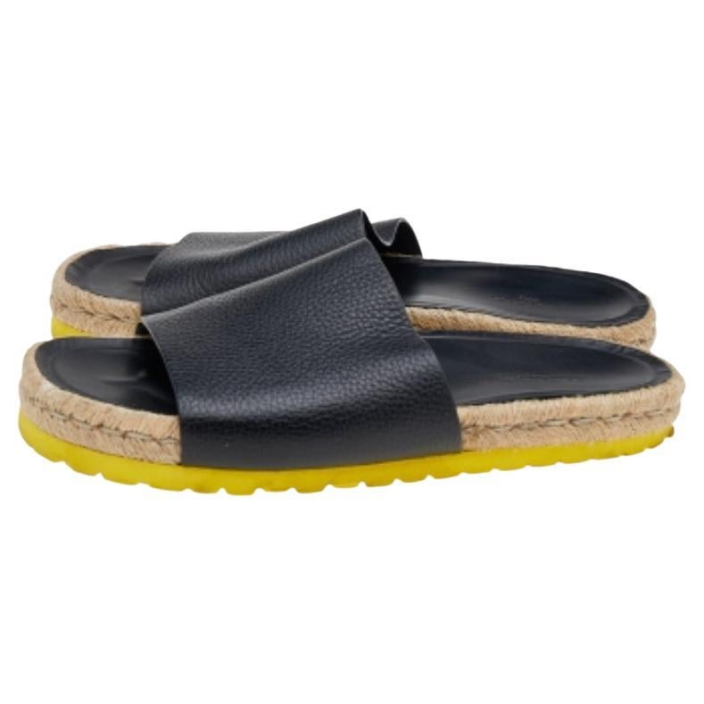 Comfort and luxe fashion come combined in these flats from Balenciaga! They are designed with broad leather straps, espadrille midsoles, and rubber soles. The black slides are made for your casual style and for days at the pool.
