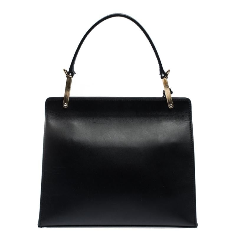 Dieses Balenciaga-Design strotzt nur so vor Luxus und Schönheit! Sie ist aus Leder gefertigt und mit einer Frontklappe und einem oberen Griff ausgestattet. Der schwarze Farbton ist stilvoll und der geräumige:: mit Leder ausgekleidete Innenraum hilft