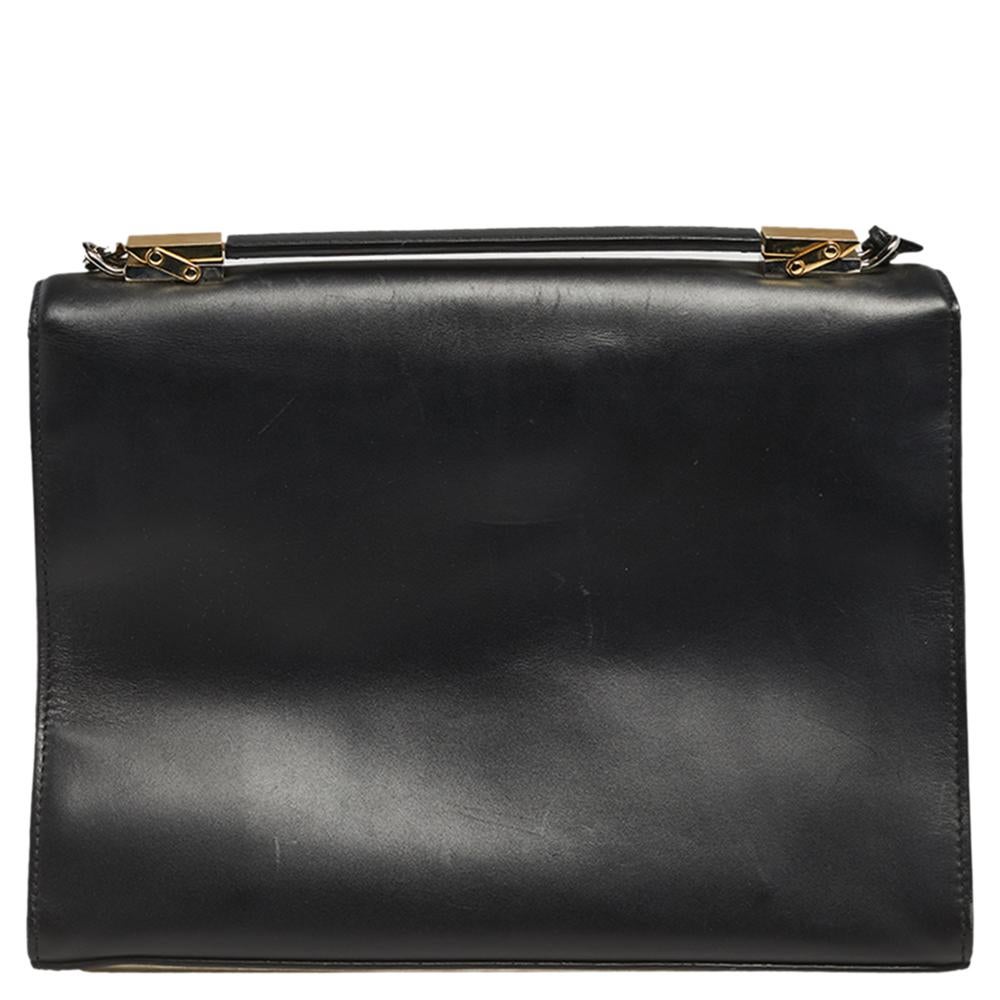 This Le Dix Cartable bag from the House of Balenciaga overflows with luxury and beauty! It has been meticulously crafted into a sturdy, structured shape and presents a functional design. It is made from black leather and is adorned with a gold-toned