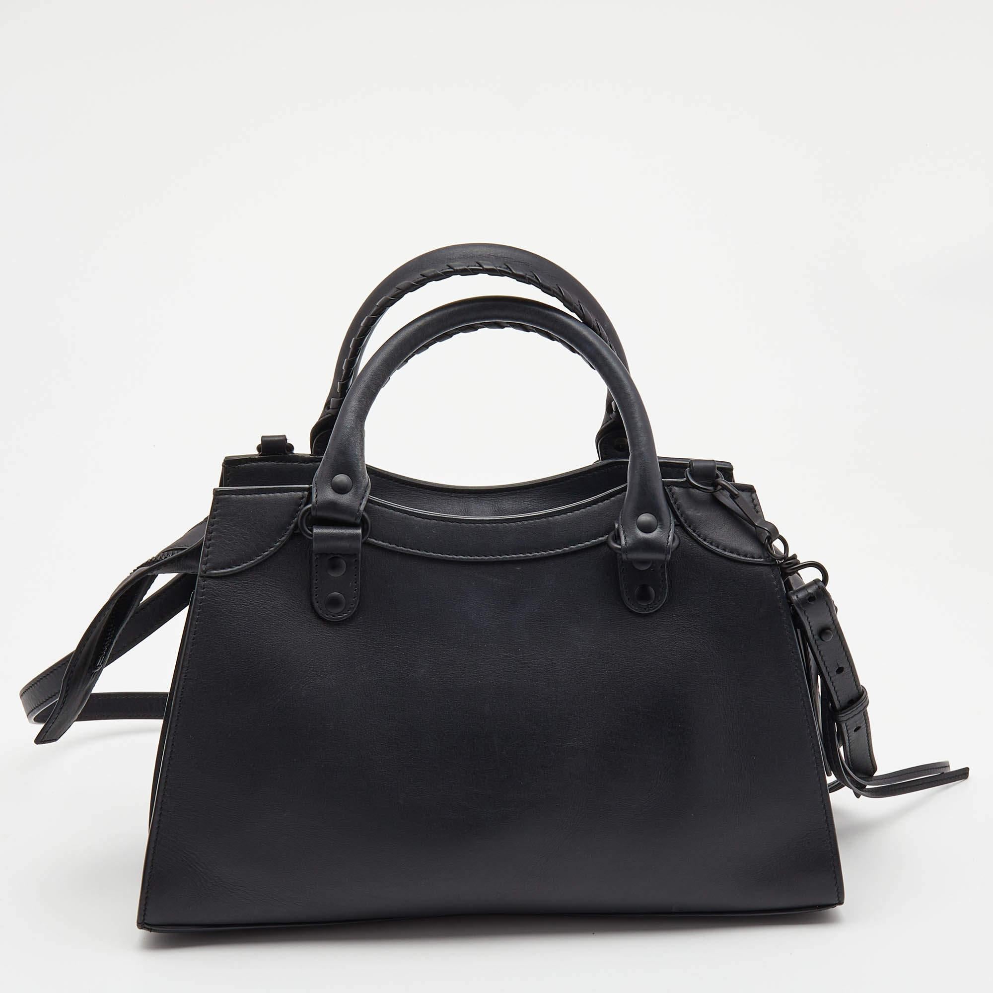 Revolutionary and visionary designs set Balenciaga apart from others, and this black creation testifies to it. The exterior of this tote is updated with chic and striking black-tone accents. Crafted from leather, it is equipped with a front zipper
