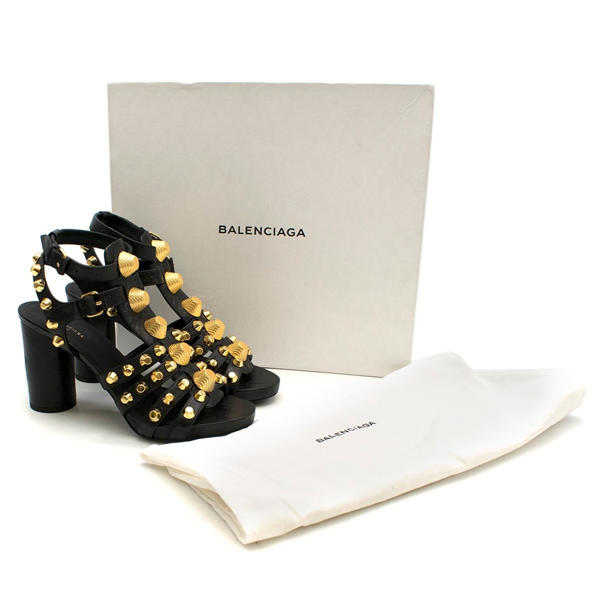 Balenciaga Black Leather Studded Heeled Sandals

- black leather sandals
- round block heel 
- gold tone stud embellished
- buckle straps to the around ankle 
- leather insole and sole

This item comes with the original dust bag and box. 

Please