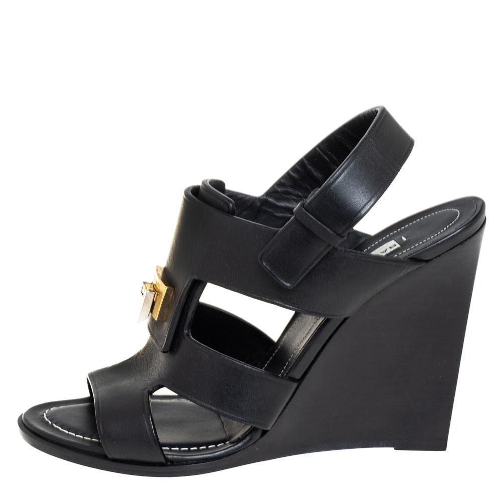 These lovely Balenciaga sandals will bring you the right amount of style and elevation. They are made of leather and feature open toes, flip lock accent on the uppers, back straps, and 11 cm wedge heels. They look great and they're easy to flaunt!