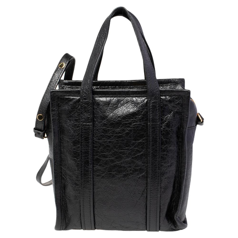 Balenciaga gives a luxurious touch to our everyday errand partner, the shopping bag via this creation. Made from leather, the bag has a black hue and handles, all very cleverly assembled to look the part of the Bazar bags you see in the market. A
