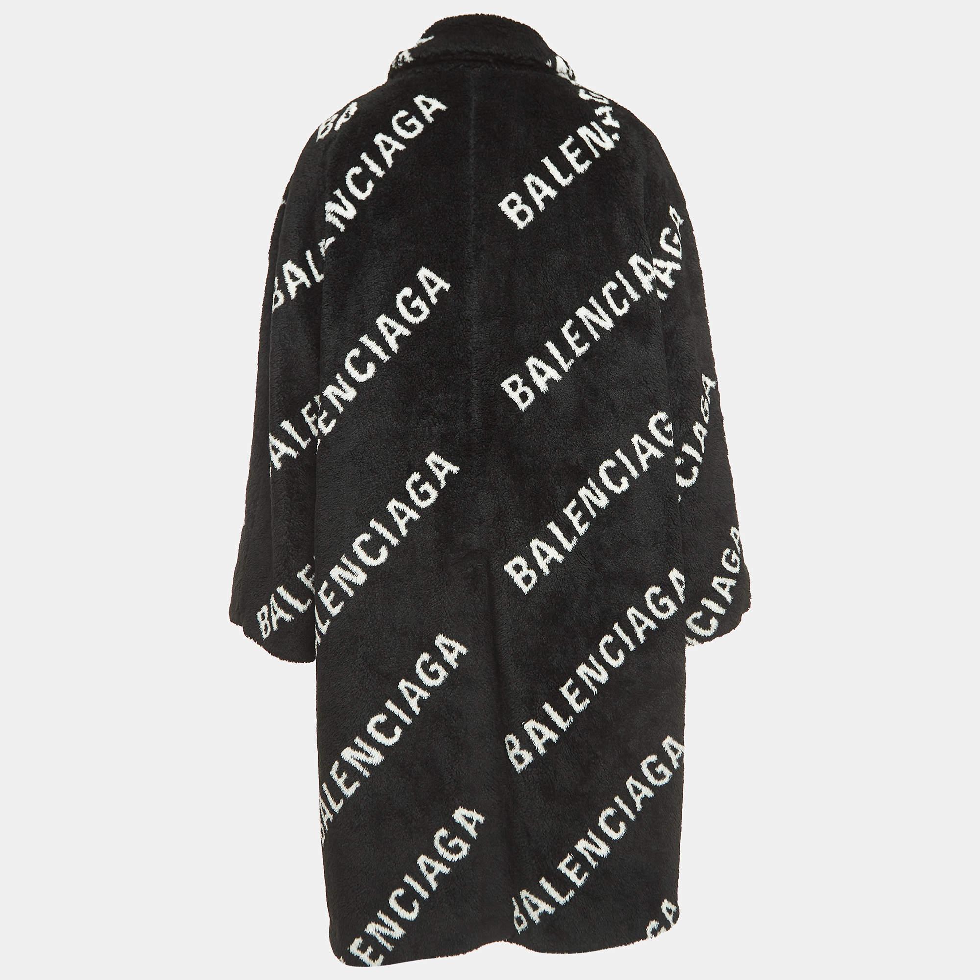 The Balenciaga coat exudes opulence with its plush faux fur and distinctive monogram pattern. Its generous silhouette and sleek black hue make a bold fashion statement, ensuring both warmth and high-end style for the discerning wearer.

Includes: tag