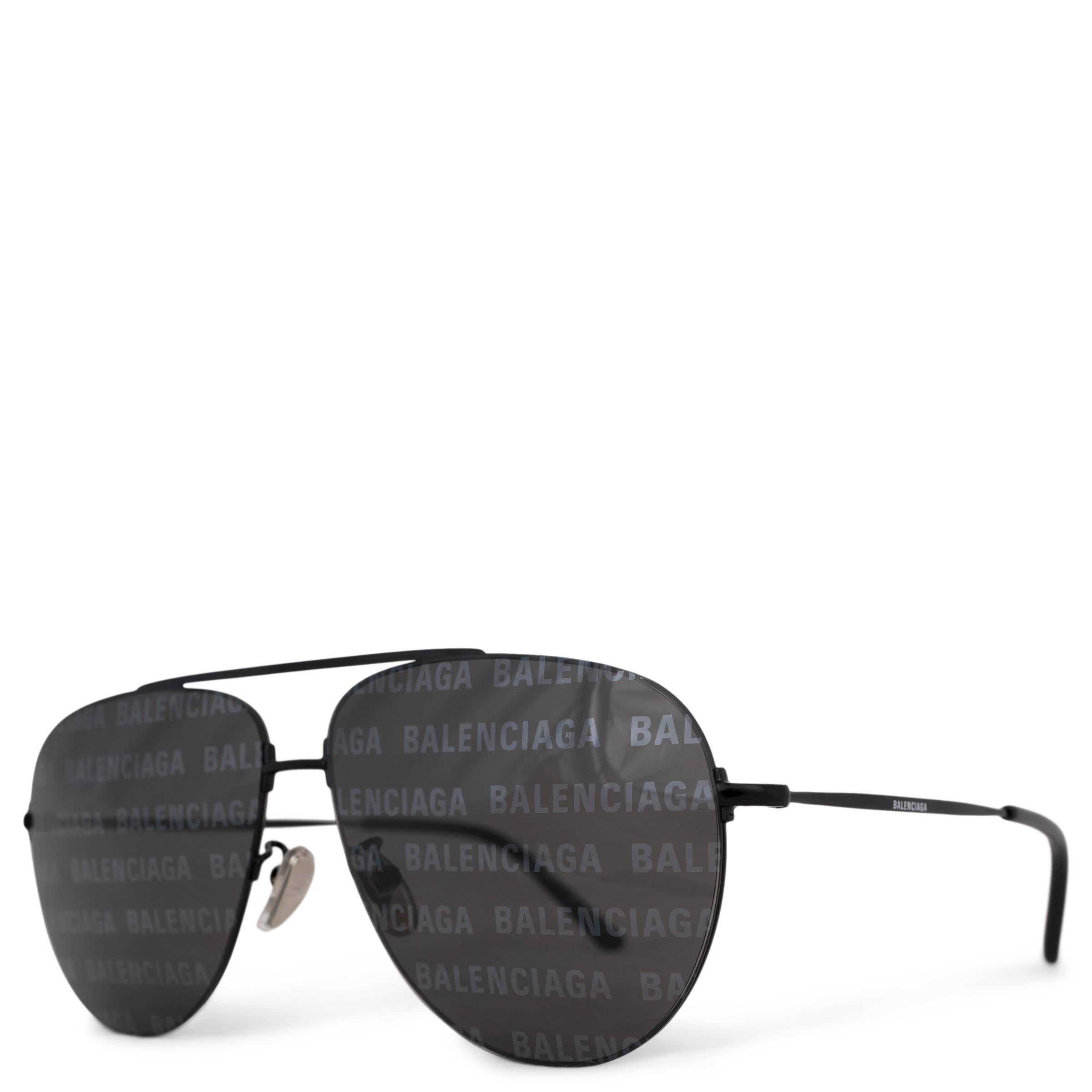 These 100% authentic Balenciaga BB0013S Sunglasses showcase a sleek design with the Balenciaga logo subtly repeated across the grey lenses, offering a unique look while maintaining a clear, uninterrupted view. Crafted from ultra-thin metal, these