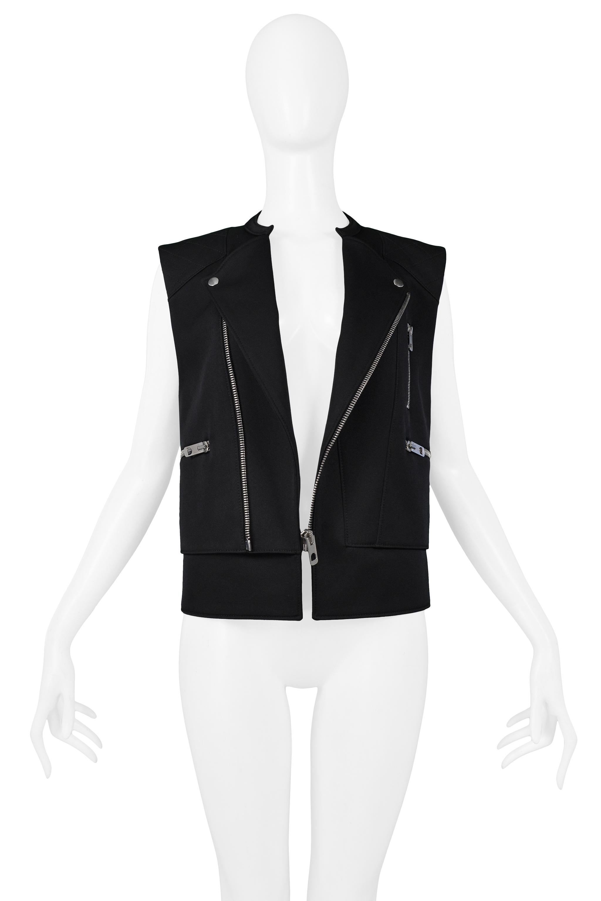 Resurrection Vintage is excited to offer a vintage Balenciaga by Nicolas Ghesquière black moto vest featuring silver-tone hardware, an asymmetrical zipper closure, and three zipper pockets. 
Balenciaga Paris
Designed By Nicolas Ghesquiere
Size