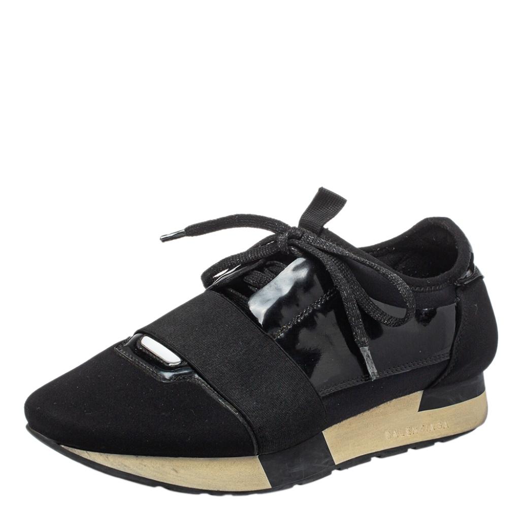 Let your latest shoe addition be this pair of Balenciaga Race Runners sneakers. These sneakers have been crafted from neoprene, and patent leather and feature a chic silhouette. They flaunt covered toes, strap detailing on the vamps, and tie-up