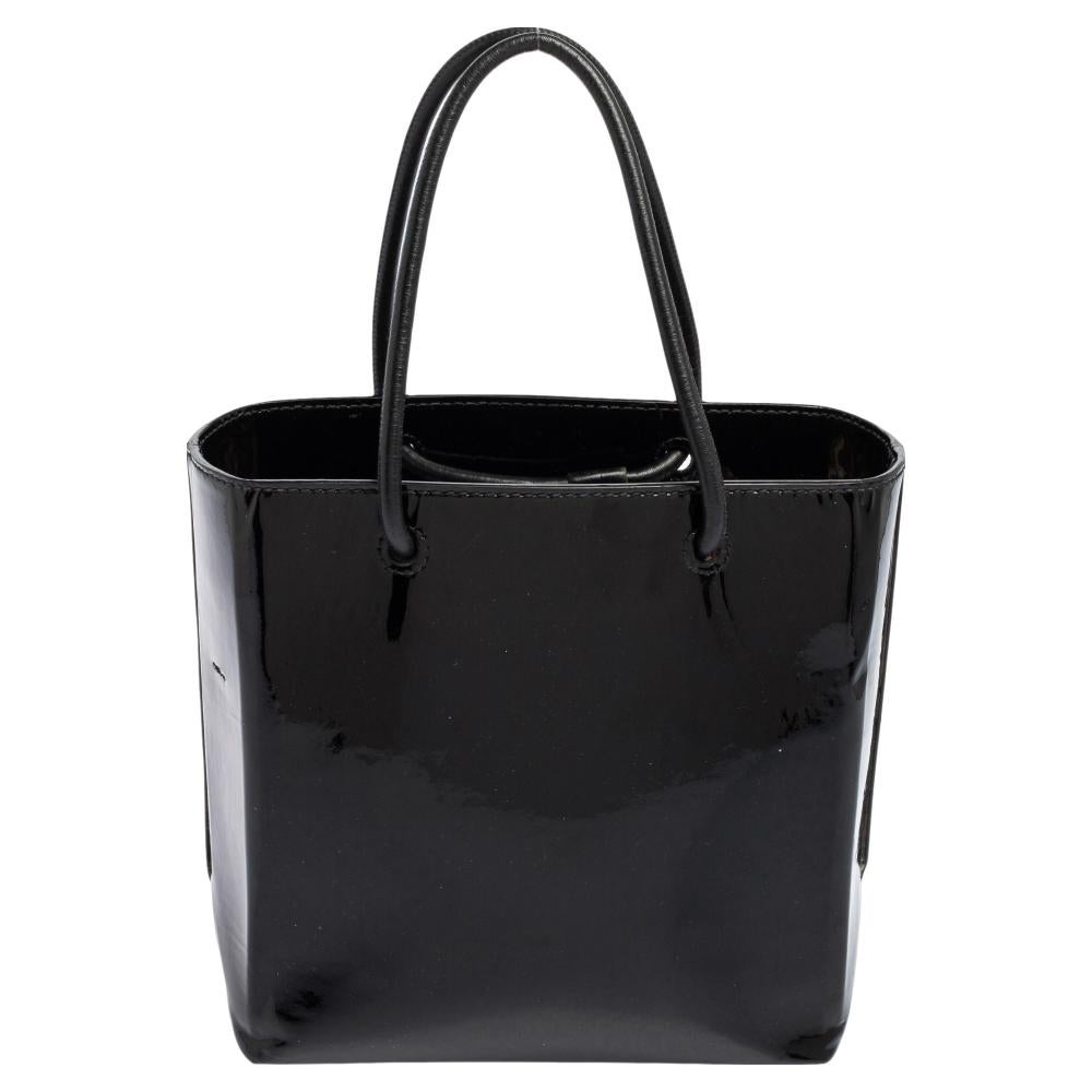 Don't think twice about getting this absolutely stylish North South tote from Balenciaga. Designed like a shopping bag, this bag comes crafted from patent leather and added with the brand label on the front, two handles on top, and a shoulder strap