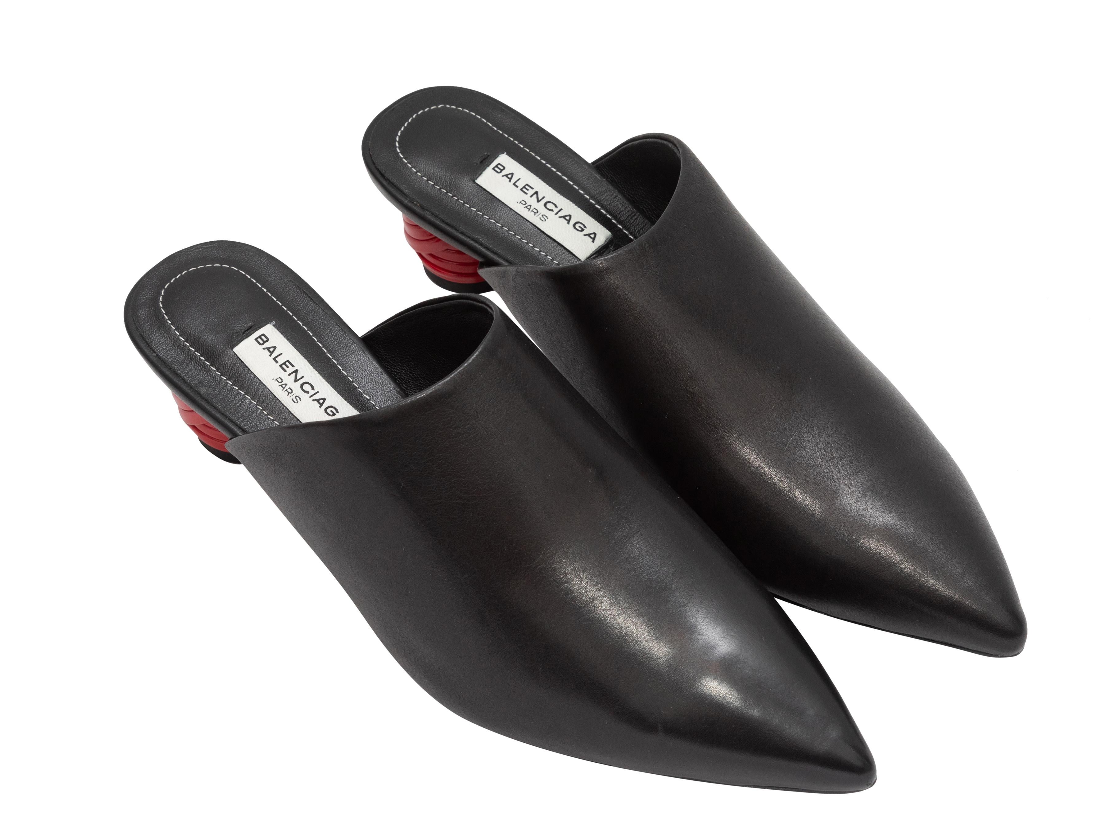 Product Details: Black leather pointed-toe Bistrot mules by Balenciaga. Red heels. 1.5