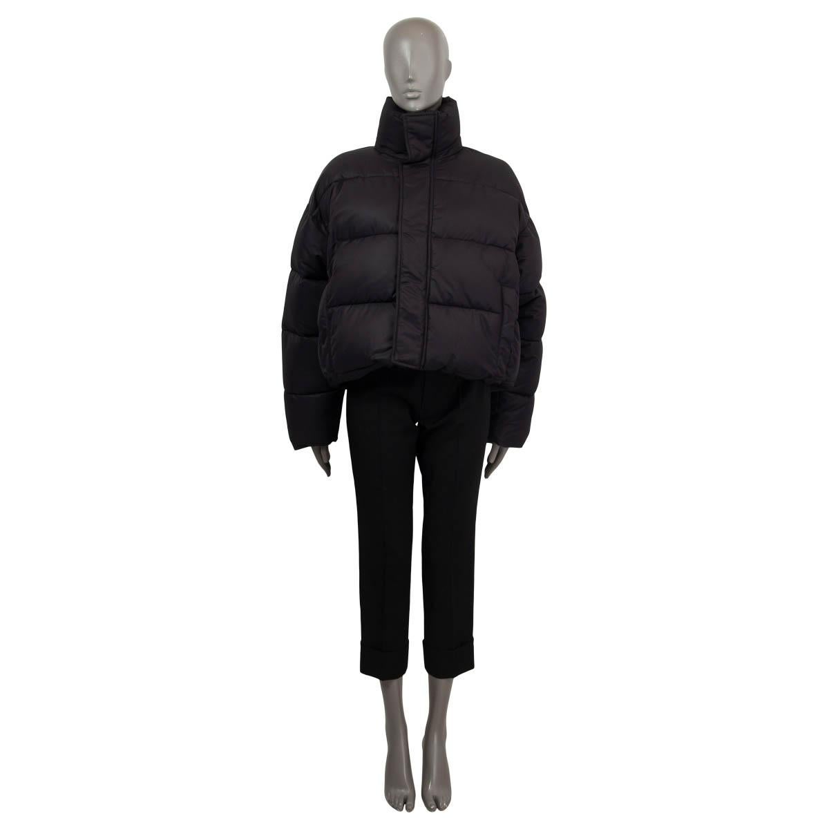 100% authentic Balenciaga BB matte cropped puffer down jacket in black polyamide (100%). Features a high neck with a concealed hood embroidered BB logo and two slit pockets on the side. Opens whit a zipper and snaps on the front. Lined polyamide