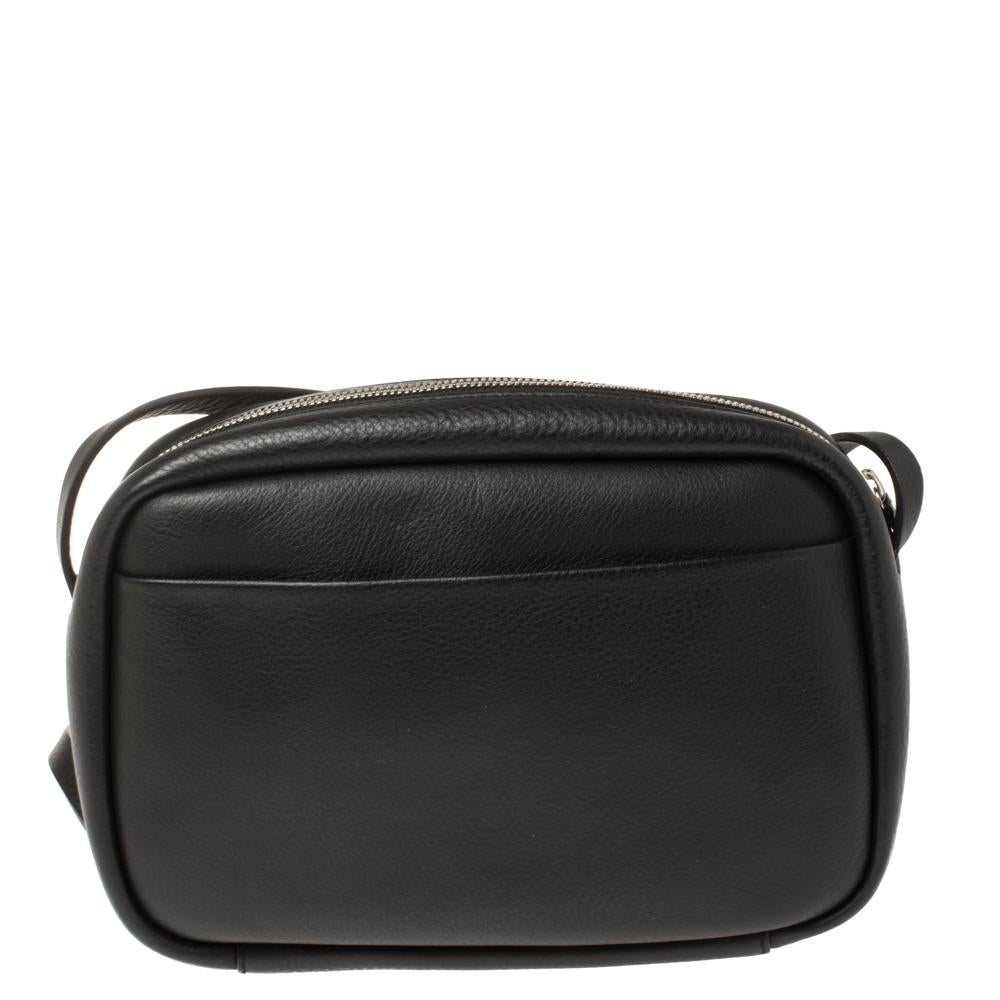 Designed to last, this beautiful bag from Balenciaga will make a prized buy. Comfortable and easy to carry, this leather creation comes in black with a puppy and kitten detailed on the front. It has a shoulder strap and an interior lined with