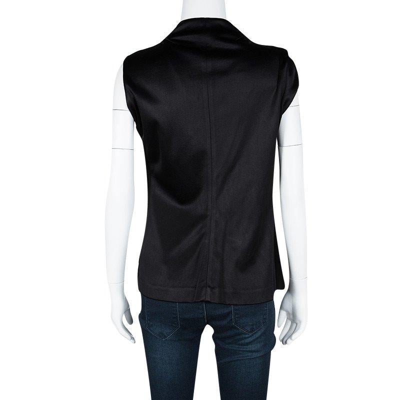 Let your closet experience a fabulous addition with this vest from Balenciaga. The satin vest has been styled with a black hue and asymmetric detailing on the front.

