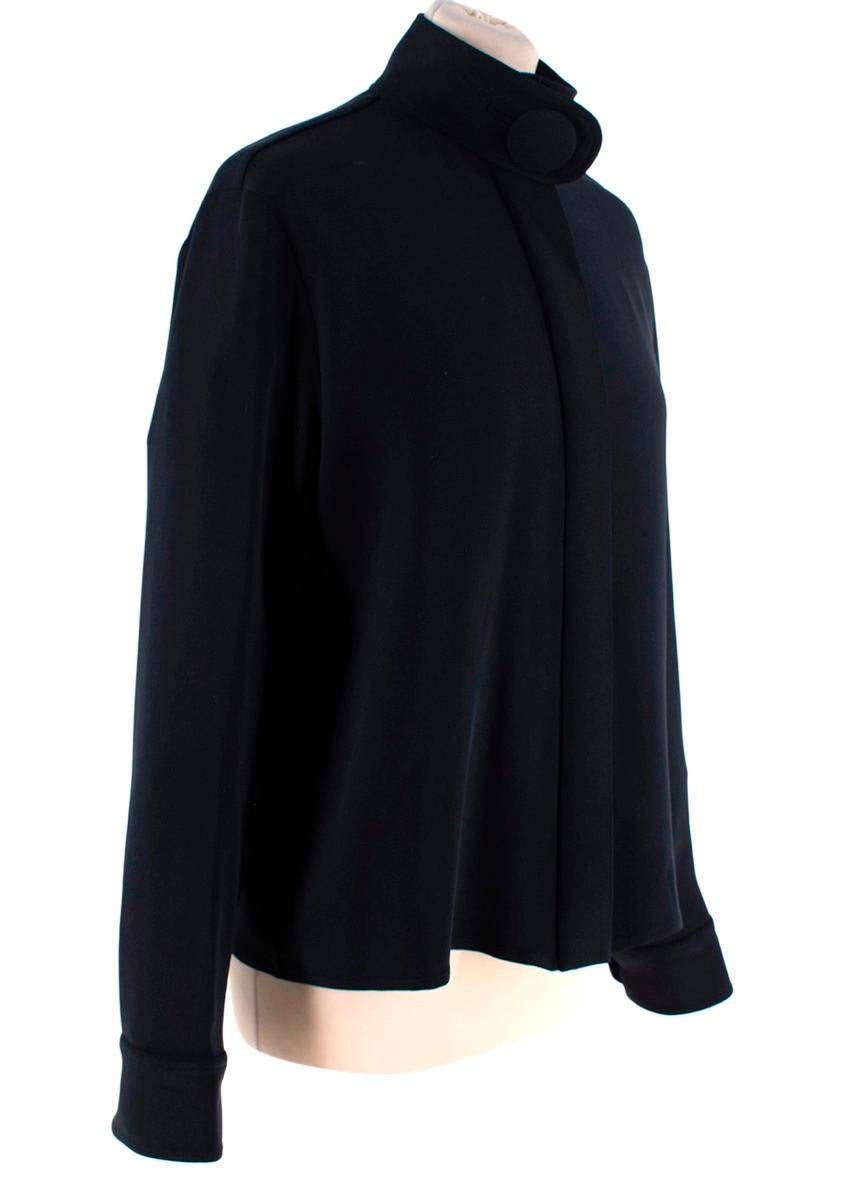 Balenciaga Black Silk Crepe Button Neck Blouse
 

 - Lightweight silk crepe long sleeve blouse with decorative oversized button collar
 - Concealed front placket 
 - Classic fit
 

 Materials 
 94% Silk
 6% Elastane 
 

 Made in Italy 
 Dry Clean 
