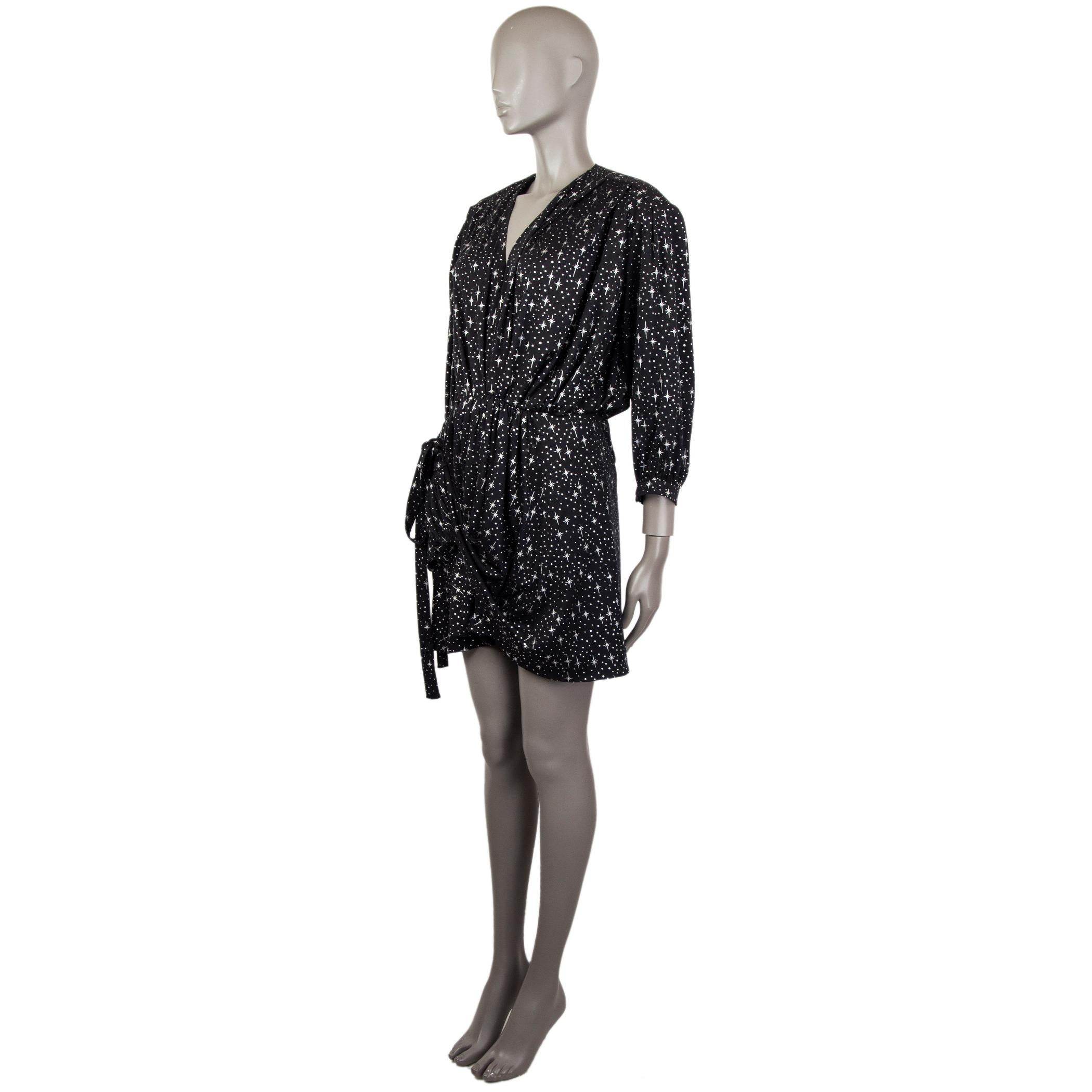 100% authentic Balenciaga stars-print dress in black and silver polyester (100%). With v neck, pleated and padded shoulders, gathered layered skirt, and buttoned cuffs. Ties from hem to the side of the waist for a draping effect. Unlined. Has been