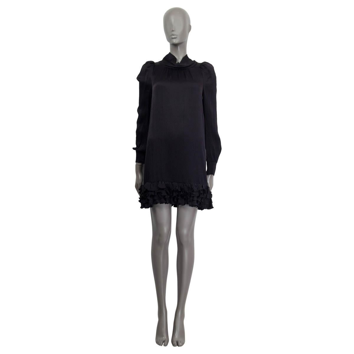 100% authentic Balenciaga long sleeve honeycomb effect mini dress in black silk (100%). Comes with buttoned cuffs and a high neck. Embellished with puffy shoulders and four rows of ruffles on the bottom of the dress. No closure. Unlined. Has been