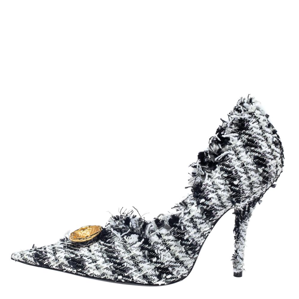 We love the fashion statement this pair makes! Using tweed to form the pump, Balenciaga adds pointed toes, gold-tone button detailing, and slim heels to complete the stunning design.

