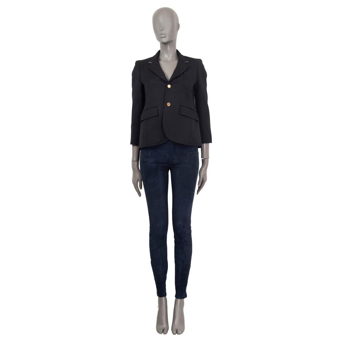 100% authentic Balenciaga cropped blazer jacket in black wool (100%). Features gold buttoned cuffs and three pockets on the front. The collar is lined in off-white. Opens with two golden buttons on the front. Lined in black cupro (100%). Has been