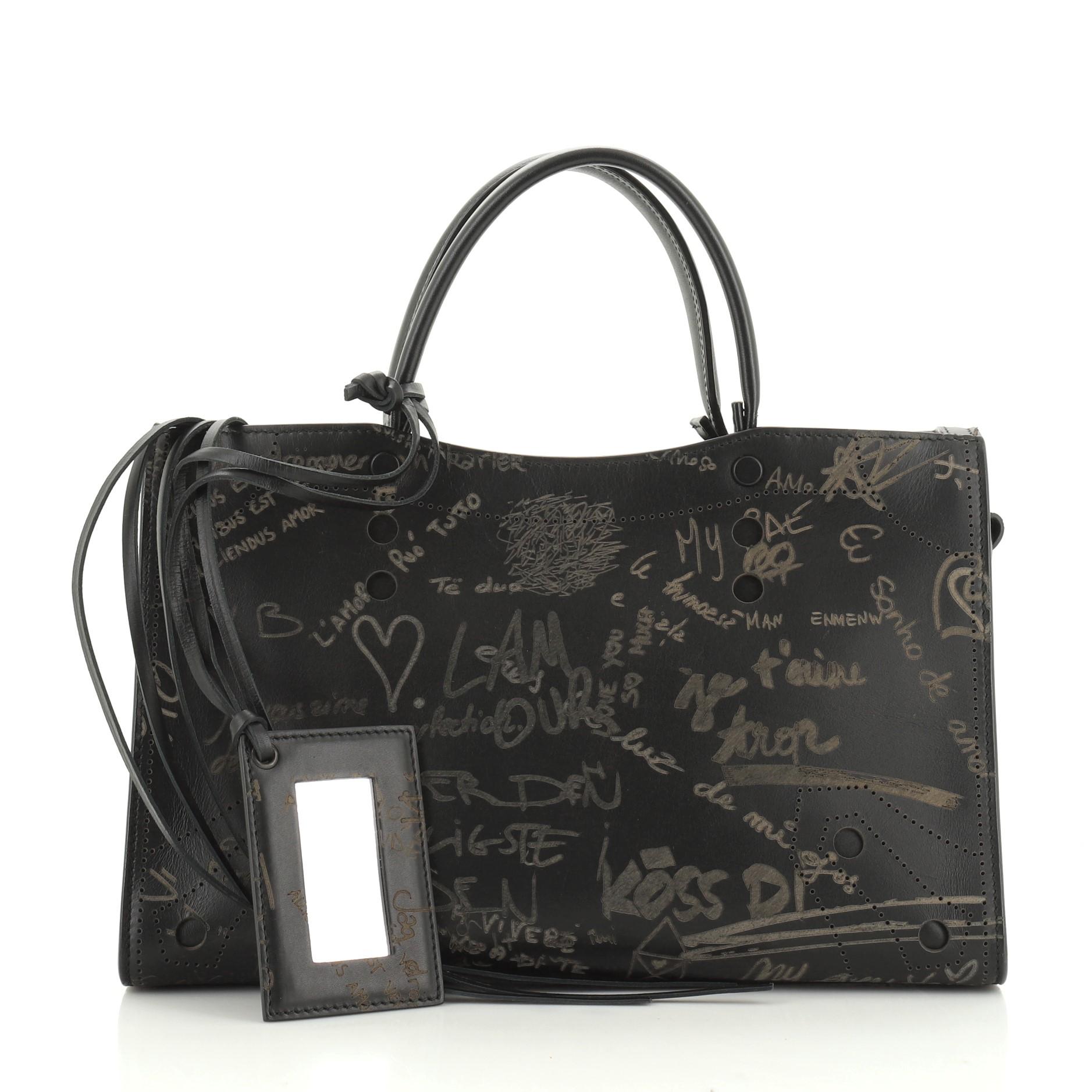 This Balenciaga Blackout City Bag Printed Leather Small, crafted in black printed leather, features dual leather handles and brass-tone hardware. Its zip closure opens to a black leather interior with zip and snap pockets. 

Estimated Retail Price: