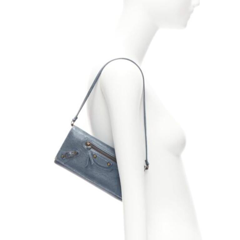 BALENCIAGA blue leather motorcycle long wallet on chain cluch bag
Reference: KNCN/A00038
Brand: Balenciaga
Material: Leather
Color: Blue
Pattern: Solid
Closure: Snap Buttons
Lining: Black Fabric
Extra Details: Detachable strap.
Made in: