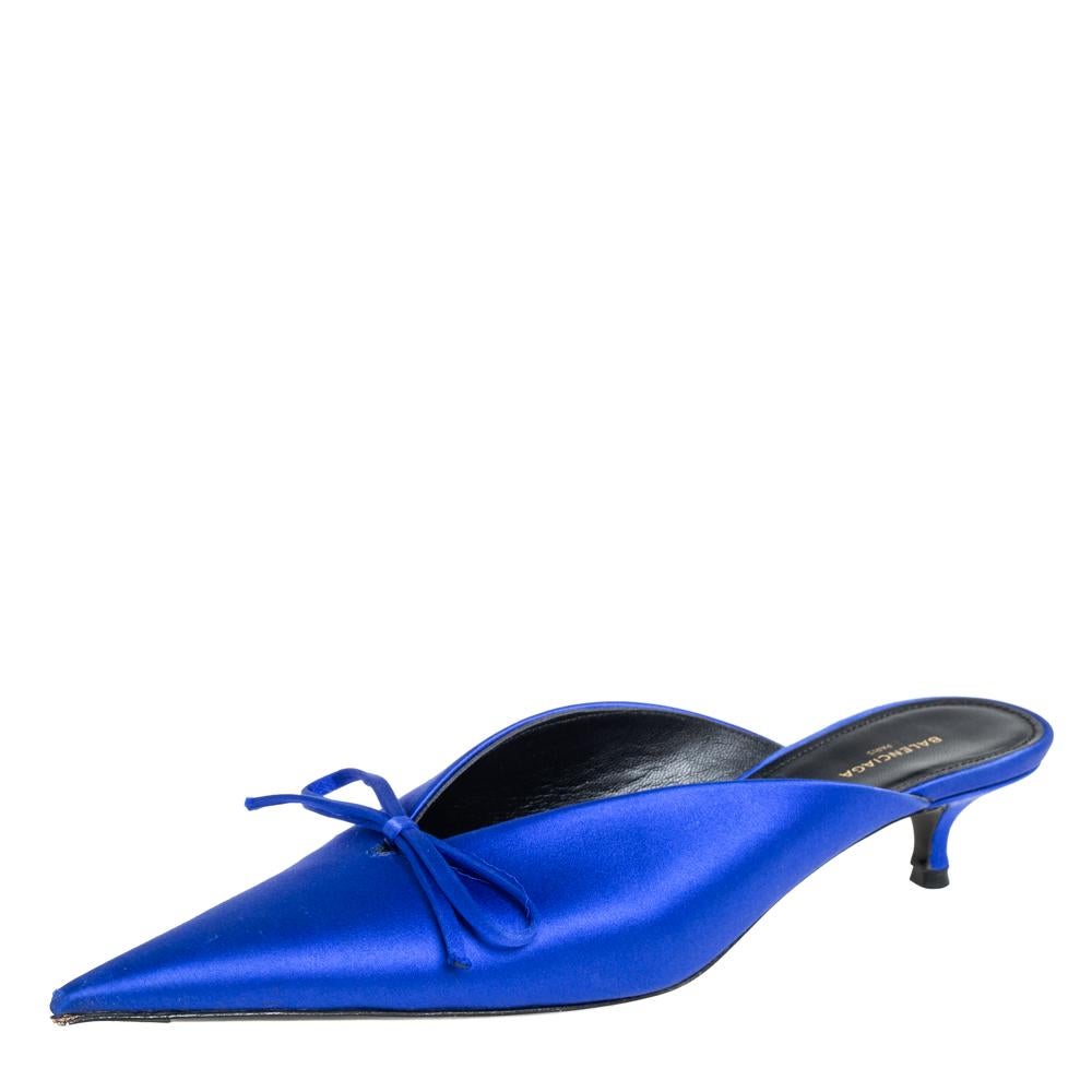 If you are an admirer of the latest fashion trends, this pair of Balenciaga mules will add just the right vibe to your closet. The pointed-toe sandals are covered in blue satin and detailed with bows on the vamps. They are elevated on 5 cm kitten
