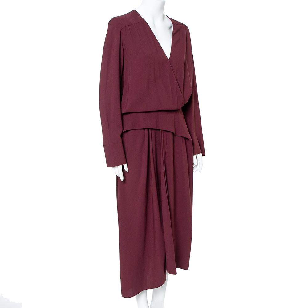 This gown from Balenciaga is simply amazing! The burgundy crepe gown features a deep V-neckline, pleat details, and long sleeves. It can be accessorized well with statement jewelry and strappy sandals for outlining a chic look.

