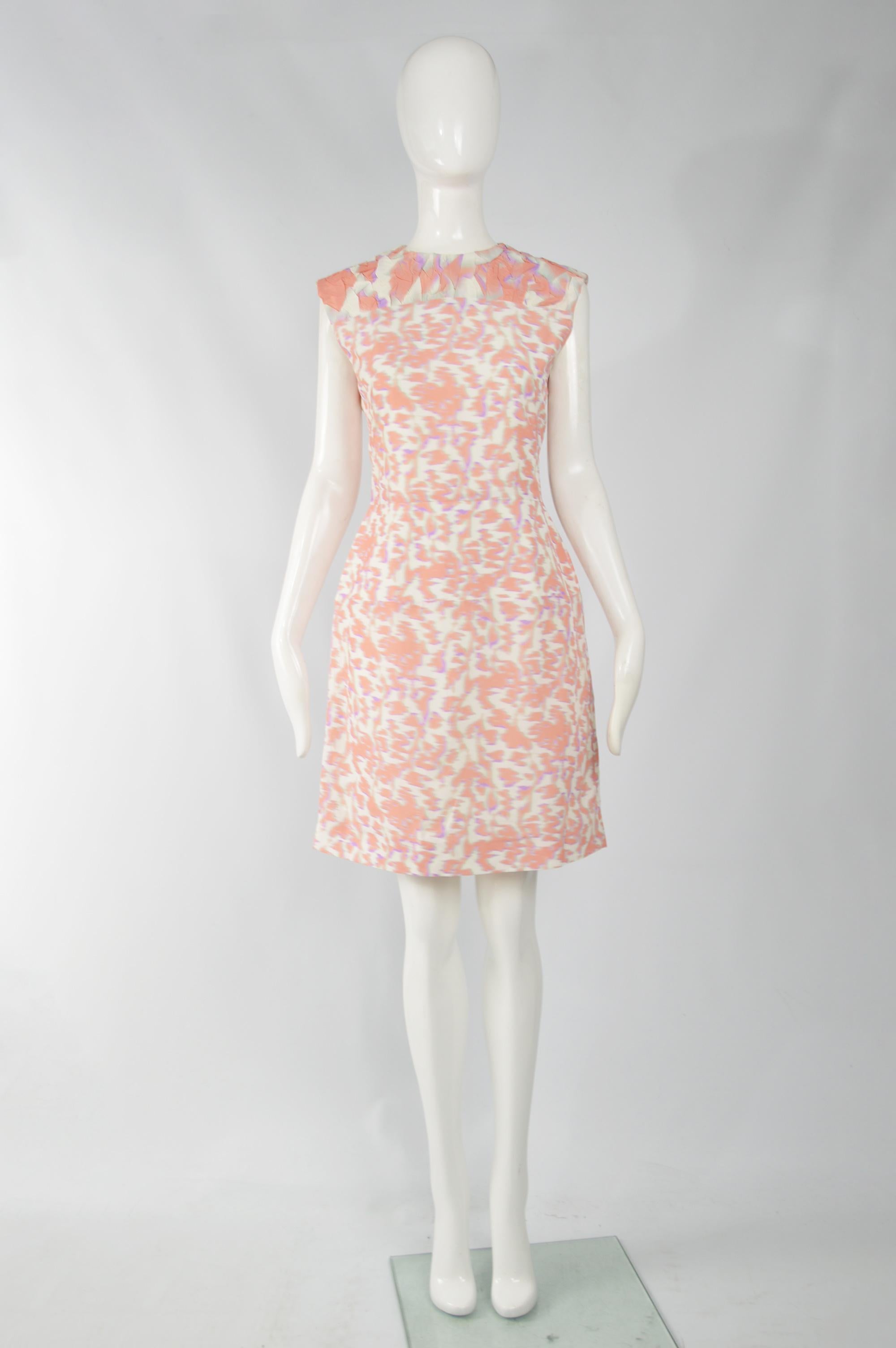 A stunning Balenciaga dress from the Spring Summer 2014 collection, designed by Alexander Wang. In a white, peach and purple acetate-silk blend with a textured, cloqué top and structured hips. Perfect for the day or at a party in the evening.

Size:
