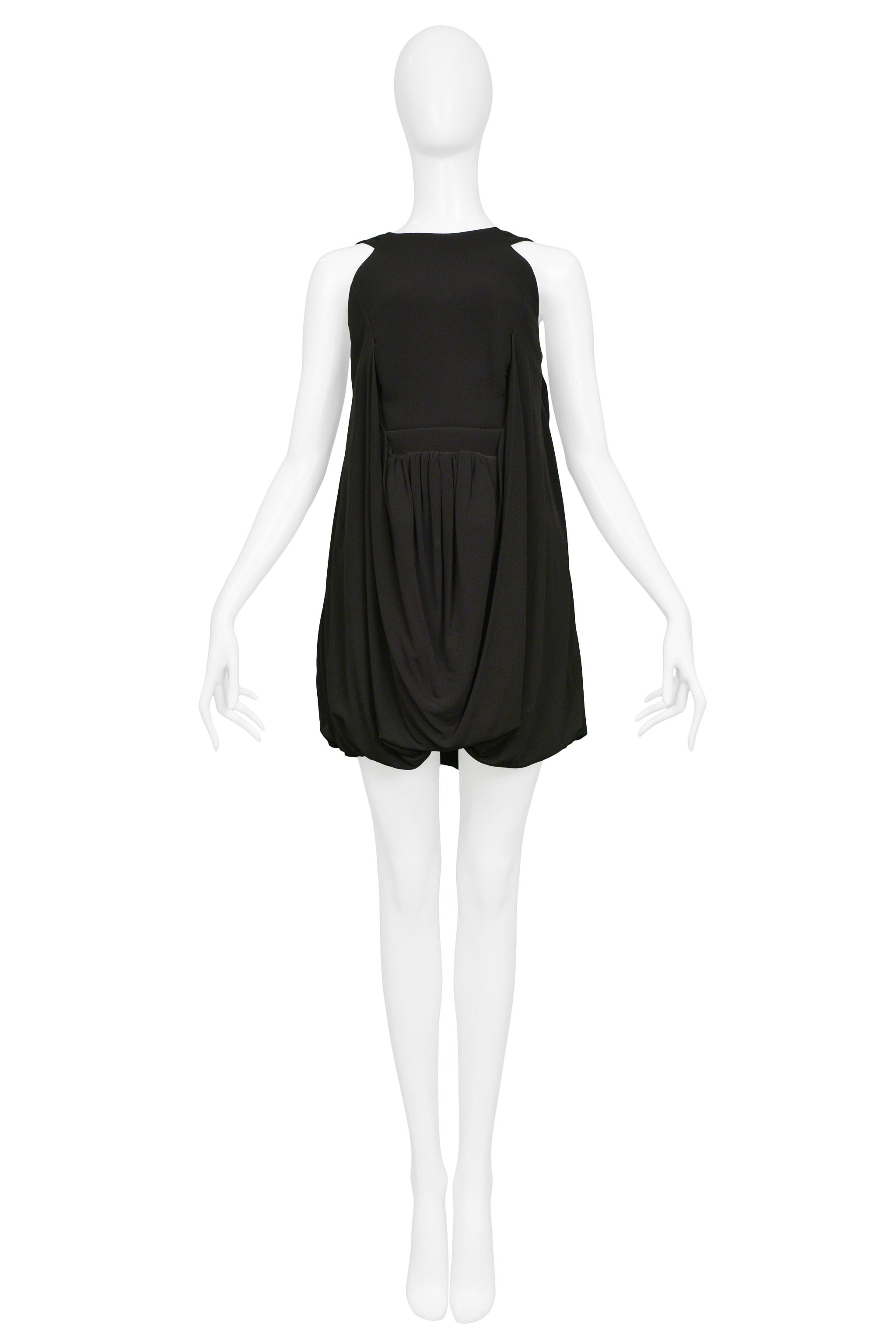 Resurrection Vintage is excited to offer a vintage Balenciaga by Nicolas Ghesquiere black viscose cocktail dress featuring an empire waistline, drape skirt, bubble hem, and side zipper.
Balenciaga Paris
Designed by Nicolas Ghesquiere
Size
