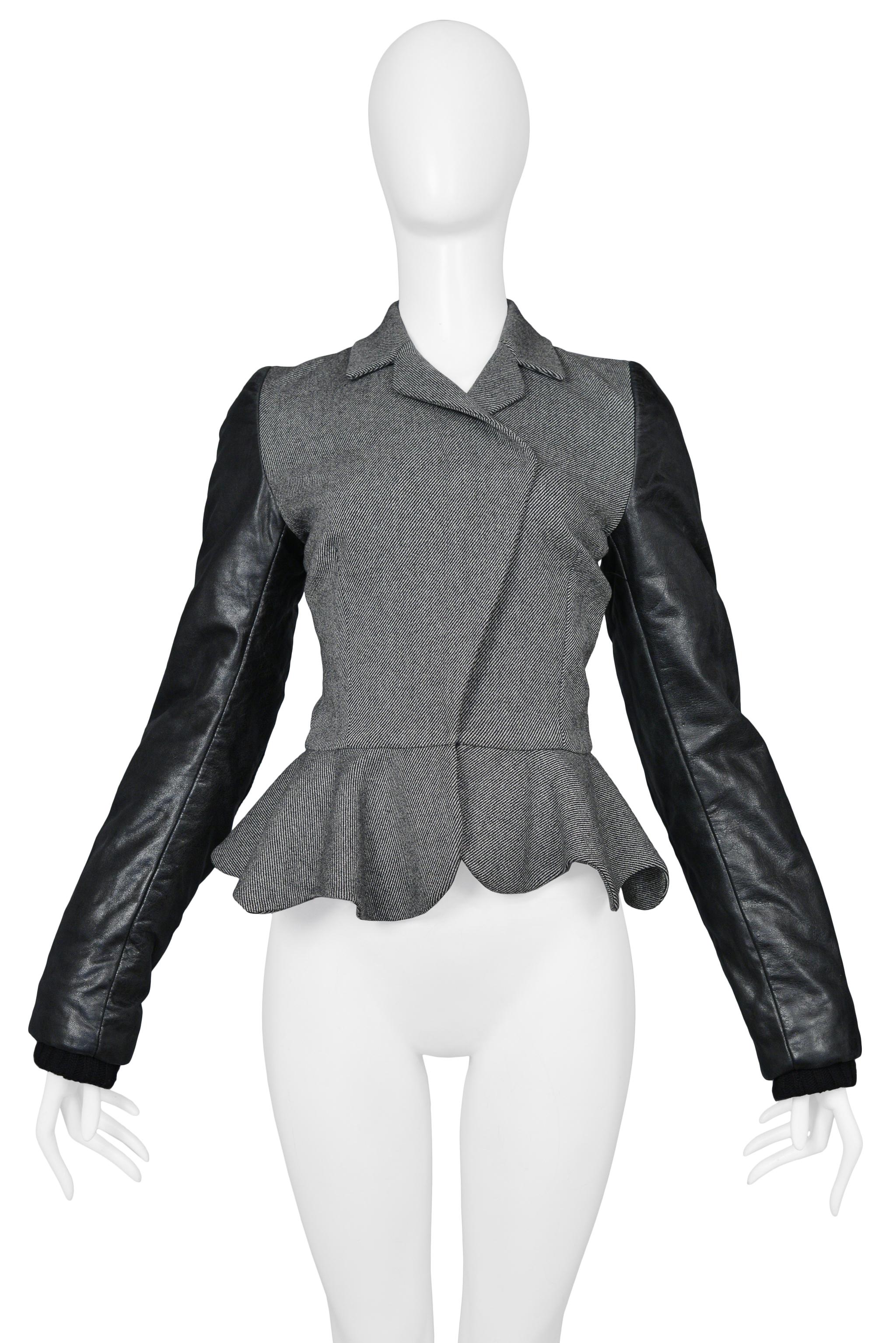 Resurrection is pleased to offer a vintage Balenciaga by Nicolas Ghesquiere grey wool jacket featuring black leather motorcycle style long sleeves, a fitted body, notch collar, and peplum. 

Balenciaga Paris
Designed By Nicolas Ghesquiere
Size