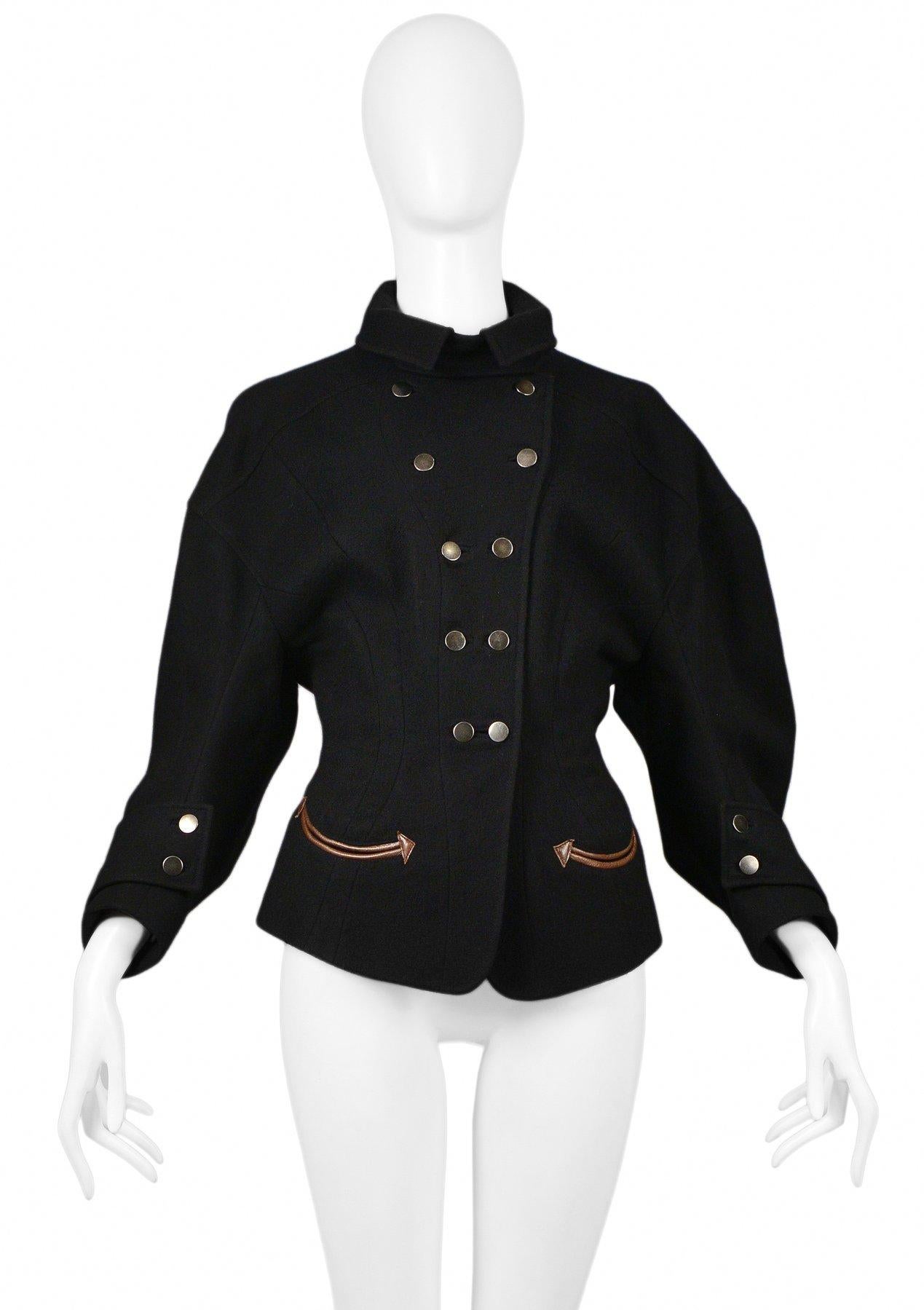 Resurrection is pleased to offer a vintage Balenciaga by Nicolas Ghesquiere black wool double-breasted jacket featuring dramatic full sleeves with snap cuffs, a flap collar, hourglass silhouette, brown leather western-inspired decorative arrow trim