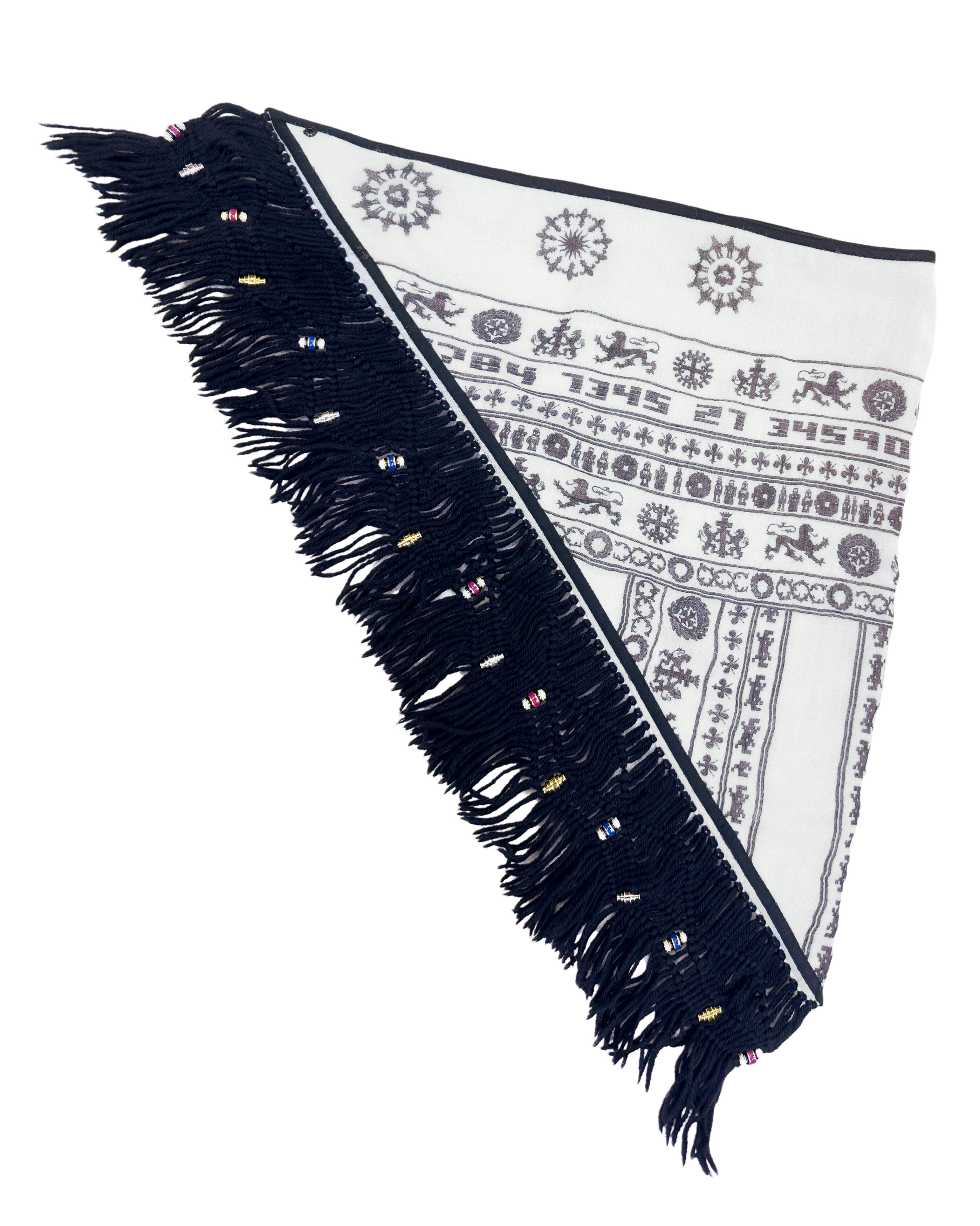 Nicolas Ghesquiere for Balenciaga Fall 2007 Keffiyeh cream and brown linen cotton woven asymmetrical scarf with abstract pattern throughout and black fringe trim featuring beautiful enamel charm embellishments.  
Length: 122cm/48in x Width: