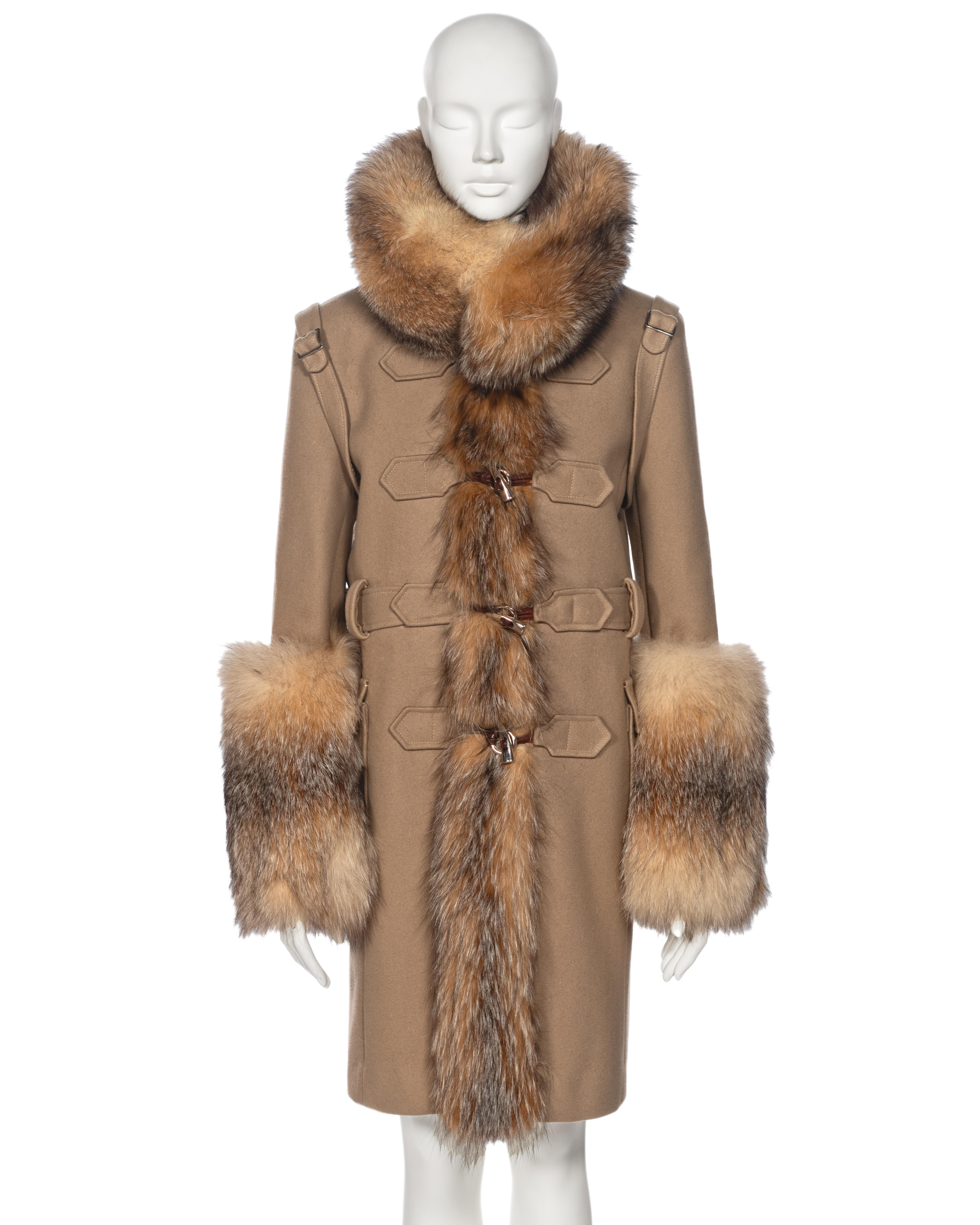 ▪ Archival Balenciaga Duffle Coat 
▪ Creative Director: Nicolas Ghesquière
▪ Fall-Winter 2005
▪ Sold by One of a Kind Archive
▪ Camel felted wool body
▪ Voluminous beaver fur collar, cuffs and trim
▪ Shoulder straps with buckle adornments
▪ Front