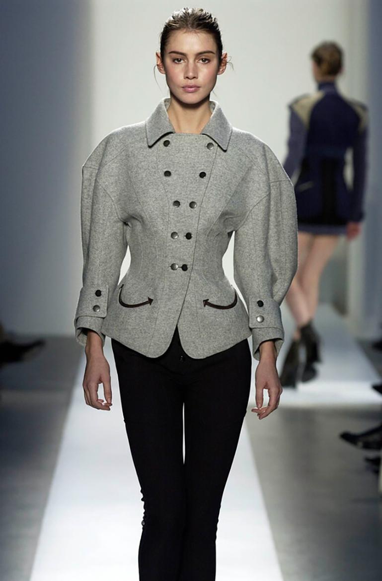 An archival treasure from Nicolas Ghesquière’s Fall 2003 Ready-to-Wear collection for Balenciaga, this sculptural double-breasted wool jacket exemplifies the designer’s talent for fusing classic tailoring with bold architectural lines and