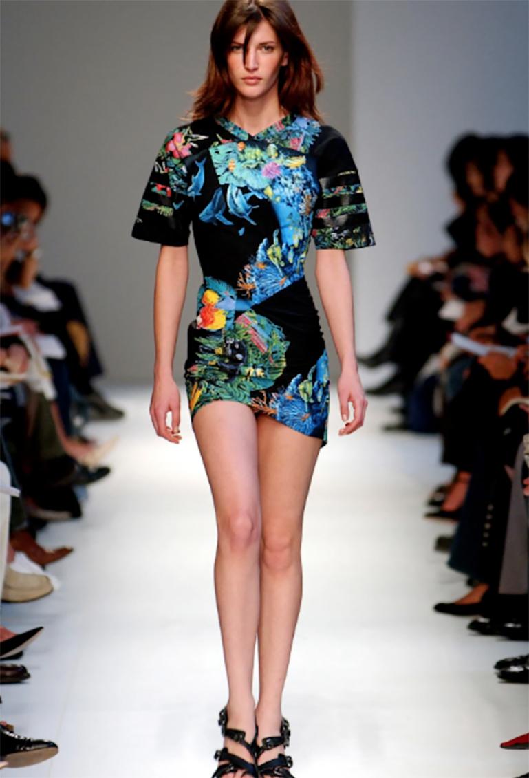 A rare and highly collectible bodycon dress from Nicolas Ghesquière’s iconic Spring/Summer 2003 runway for Balenciaga, renowned for its daring scuba-inspired silhouettes and surrealist prints. This black cotton jersey mini dress features a vivid,