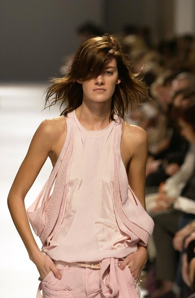 An exquisite example of Nicolas Ghesquière’s radical reinvention of draping and silhouette, this rare archival top from Balenciaga’s Spring 2002 collection (shown twice in Look 26 and 31 ) demonstrates the designer’s genius for architectural