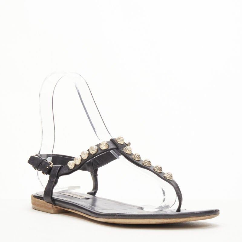 Gray BALENCIAGA Cagole black leather gold textured  stud T-strap flat sandals EU38 For Sale