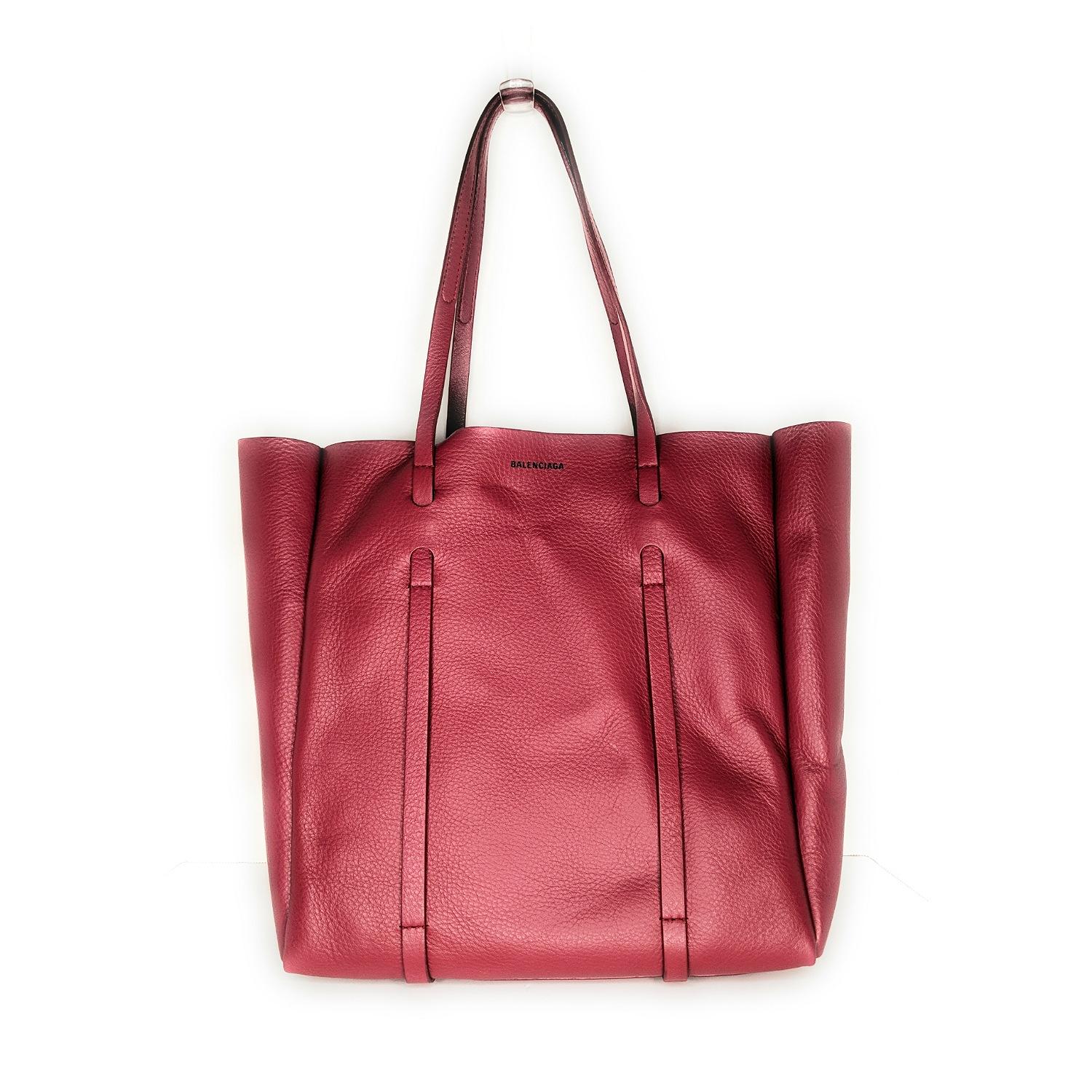 This chic tote is crafted of soft calfskin leather in Rouge. The bag features leather shoulder straps, and a wide top that is open to a smooth Black leather interior with a removable pouch. Retail price $1,185.

Designer: Balenciaga
Material: