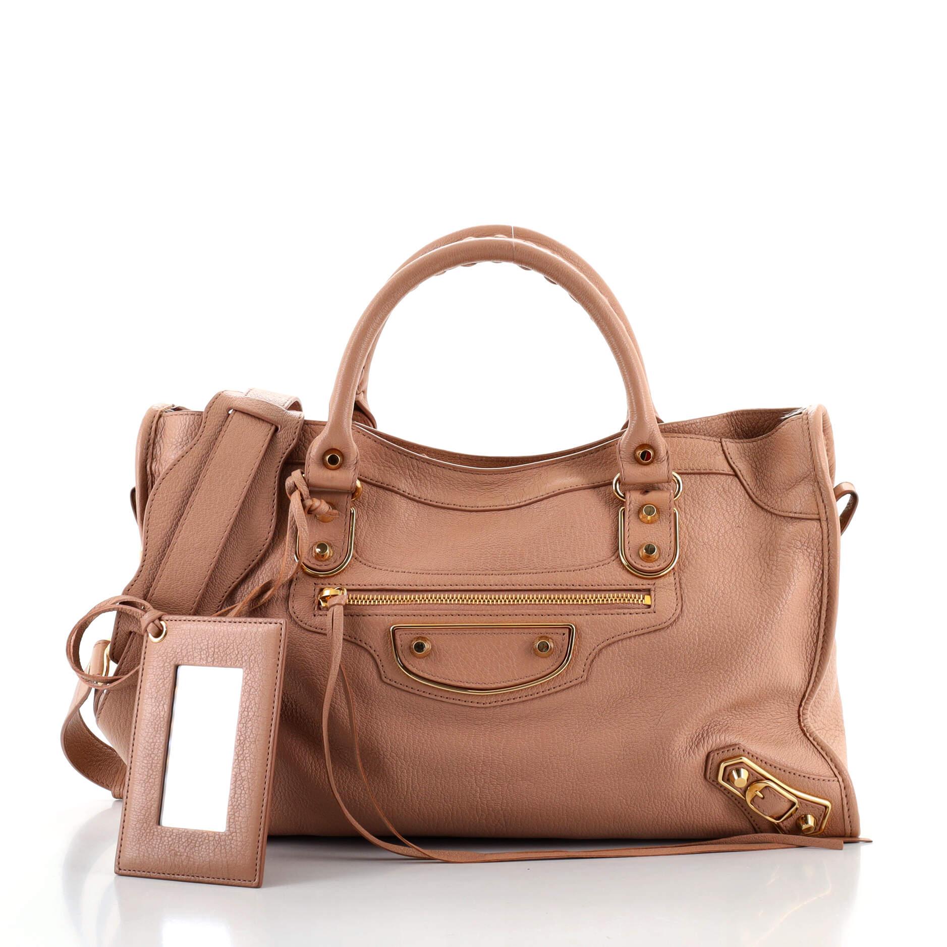 Condition: Good. Burn marks on front handle base. Odor in interior. Creasing and marks on exterior, handles and strap, glue stains on side base edges, cracking on handle wax edges. Fraying on side opening wax edges, wear in interior. Stains in