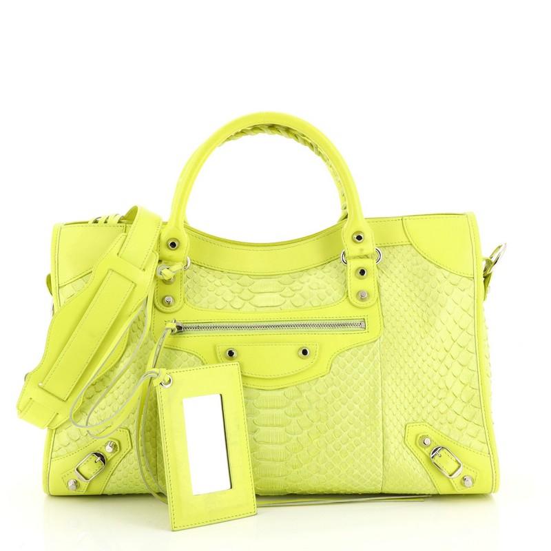This Balenciaga City Classic Studs Bag Python Medium, crafted from genuine green python, features dual braided woven handles, stud and buckle details, exterior front zip pocket, and silver-tone hardware. Its top zip closure opens to a black leather