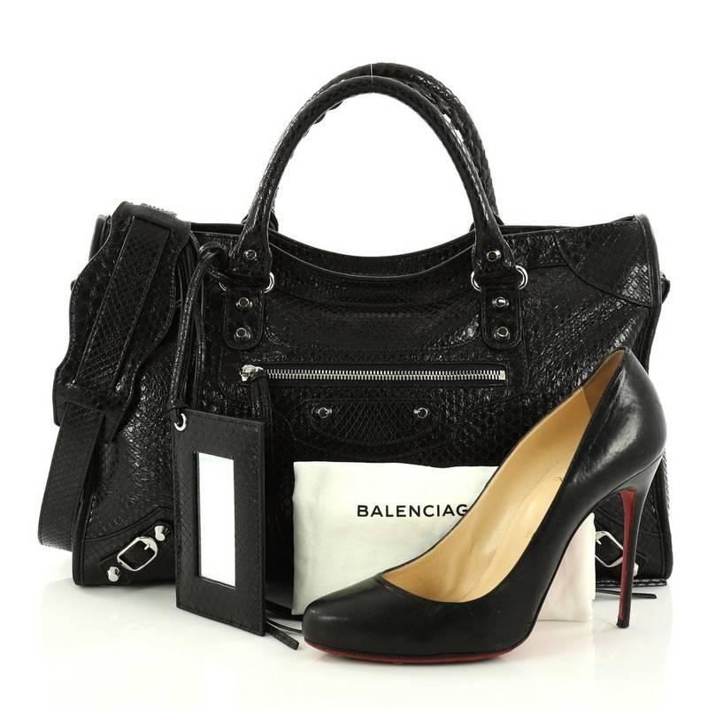 This authentic Balenciaga City Classic Studs Handbag Python Medium updates the classic city style with an exotic twist. Constructed in genuine black python skin, this popular bag features dual braided woven handles, front zip pocket, iconic classic