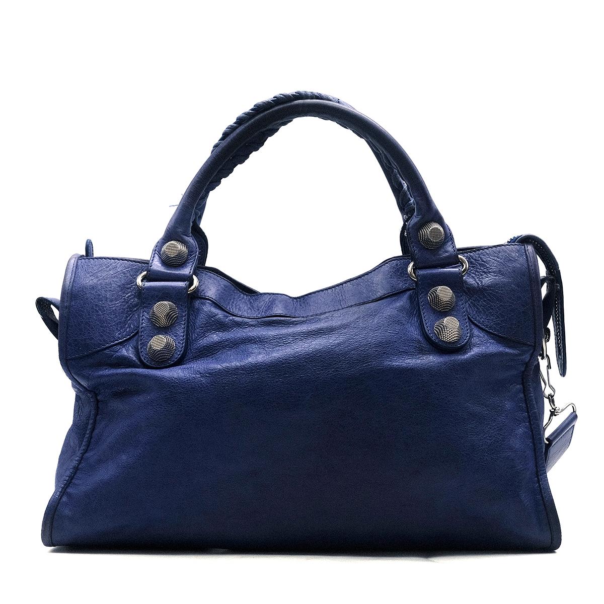 Balenciaga Classic Blue City Bag

- Blue, leather handbag
- Old brass silver-tone hardware
- Removable shoulder strap
- Hand-braided handles 
- Top zip fastening
- Large internal compartment with a zip pocket
- Front zip pocket
- This item comes