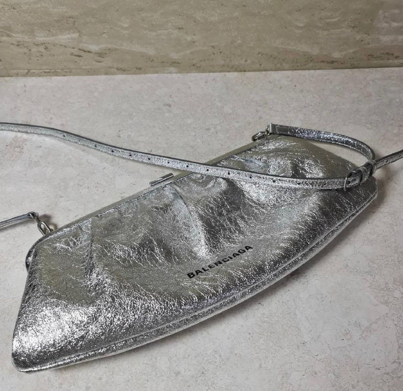 Tap into Balenciaga's confident style with this silver iteration of the Cloud bag, named after the elongated and gathered shape. It's made in Italy from crackled leather with a structured frame nodding to vintage purses and lined in black organic