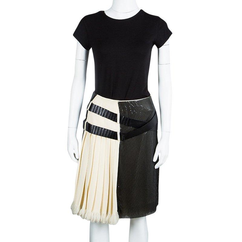 This statement style from Balenciaga is bold and effortless. The contrasting pattern and play of silk and elastane fabrics makes it distinct. The pleated panels are further accented by the belt details at the front. The knee length skirt is perfect