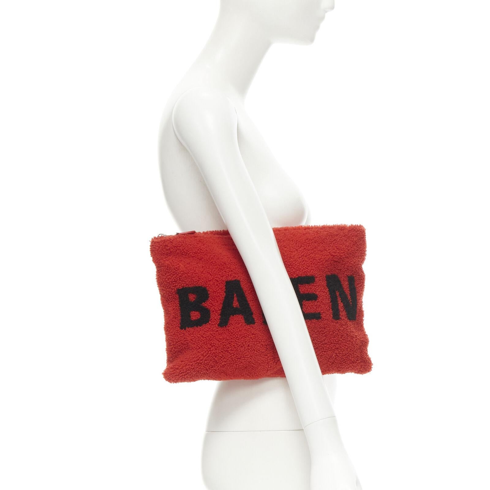 BALENCIAGA Demna logo red black dyed merino lamb shearling zip clutch bag
Reference: TGAS/C00458
Brand: Balenciaga
Designer: Demna
Model: 4926810E91N 6490
Material: Shearling
Color: Red, Black
Pattern: Solid
Closure: Zip
Lining:  Leather
Extra