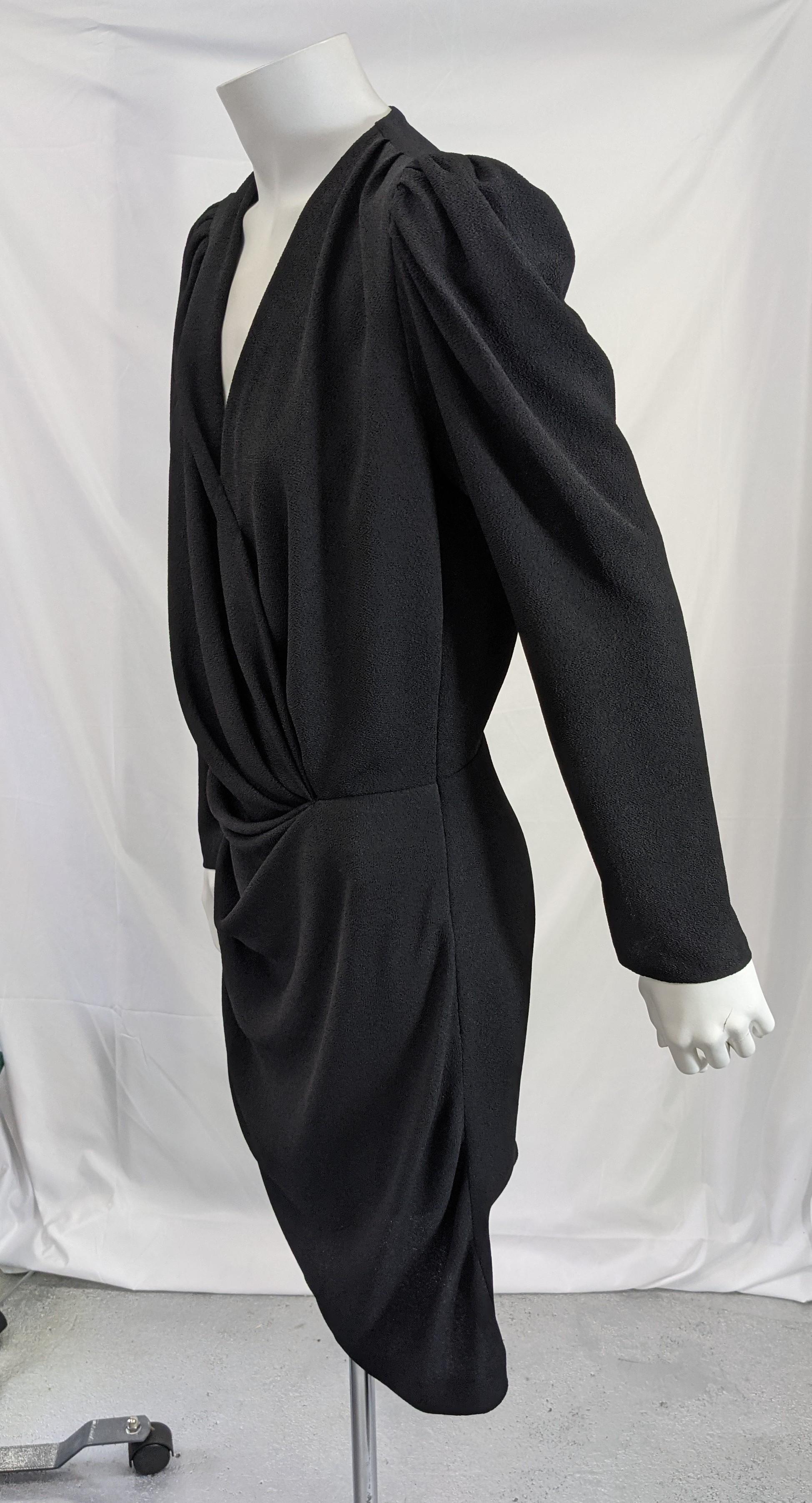 Elegant Balenciaga draped jersey dress in black with gathered side seams and slightly puffed sleeves. Pull over style with side zip closure, designed as draped faux wrap dress. 
Please note mannequin is too small for dress so it isnt laying