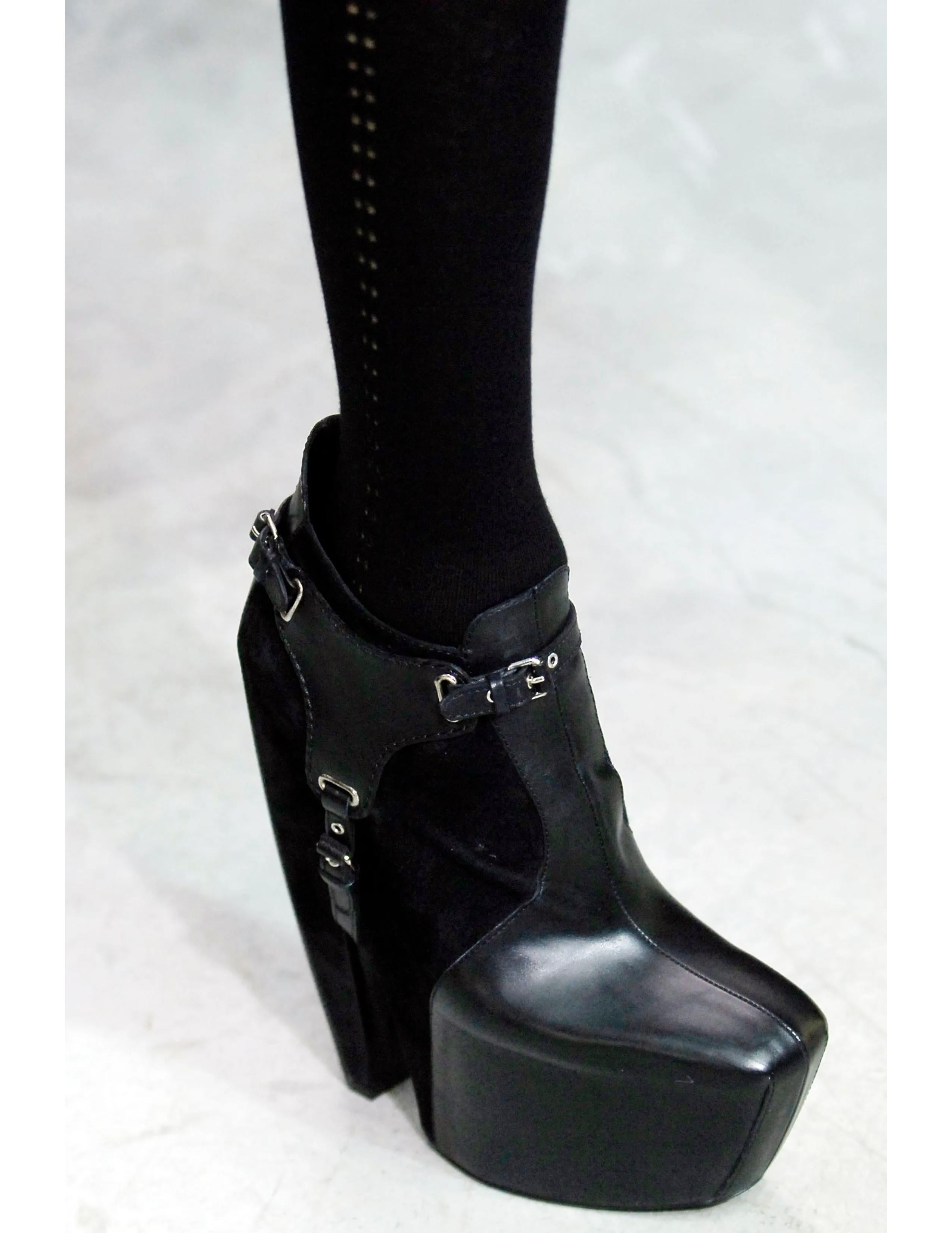 Balenciaga Fall 2006 by Nicolas Ghesquière black leather and suede ankle platform boots w removable harness and side zipper. Worn and loved by style icons such as Mary Kate Olsen.

These are the runway version of the boots featuring extra tall