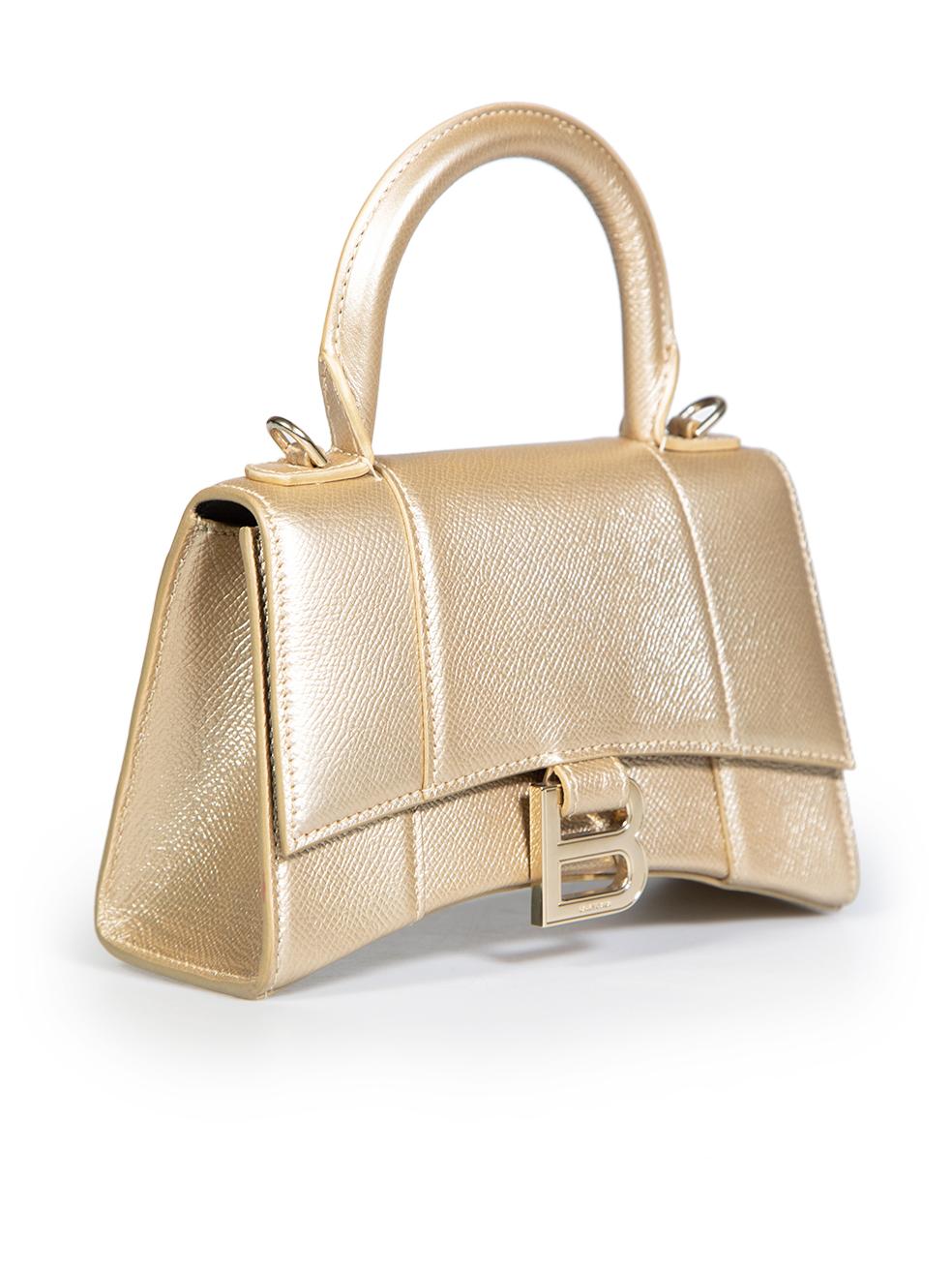CONDITION is Very good. Hardly any visible wear to bag is evident on this used Balenciaga designer resale item. This item comes with a dust bag.
 
 Details
 Model: Hourglass
 Gold
 Leather
 Detachable straps
 Gold hardware
 Magnetic closure
 1