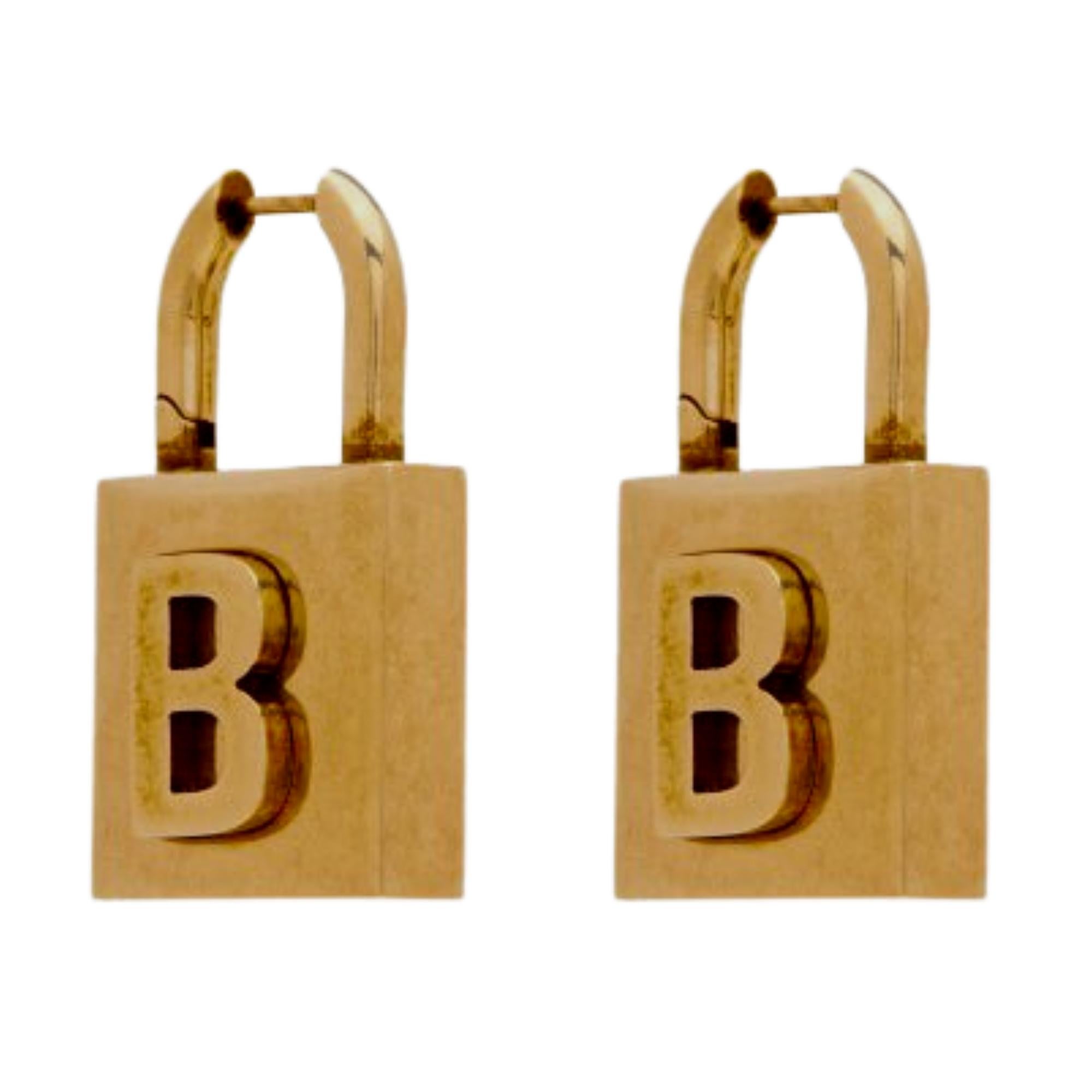 These Balenciaga drop earrings are constructed of antiqued gold-tone brass and feature logo engraving on the padlock pendant at face. Hinged-post fastening.

Color: Antique gold tone
Material: Brass
Marks: Logo stamp & Made in Italy 
Clasp Style: